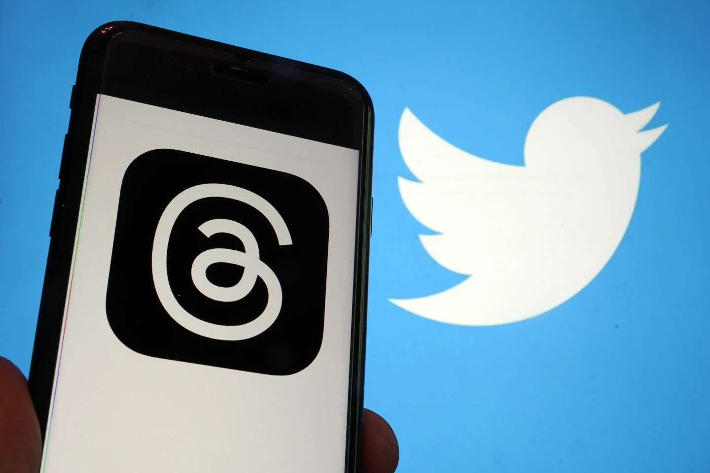 This photo, taken in New York on Wednesday, July 5, 2023, show the logo for Meta's new app Threads, left, and that of Twitter. Meta is poised to unveil the new app that appears to mimic Twitter - a direct challenge to the social media platform owned by Elon Musk. A listing for the Threads app appeared on Apple's App Store, indicating it would be debut as early as Thursday. (AP Photo/Richard Drew)ASSIOCATED PRESS