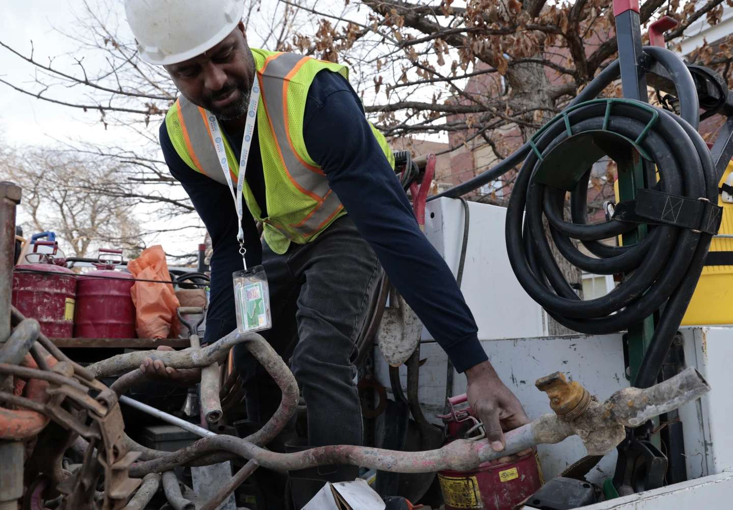 Blackhawk Sewer and Water Contractor Khaild Waarith holds a lead pipe that was extracted in Chicago on April 10, 2023. Lead pipes that carry drinking water are a major source of exposure to the metal and damage is usually permanent. (Antonio Perez/Chicago Tribune via AP)
