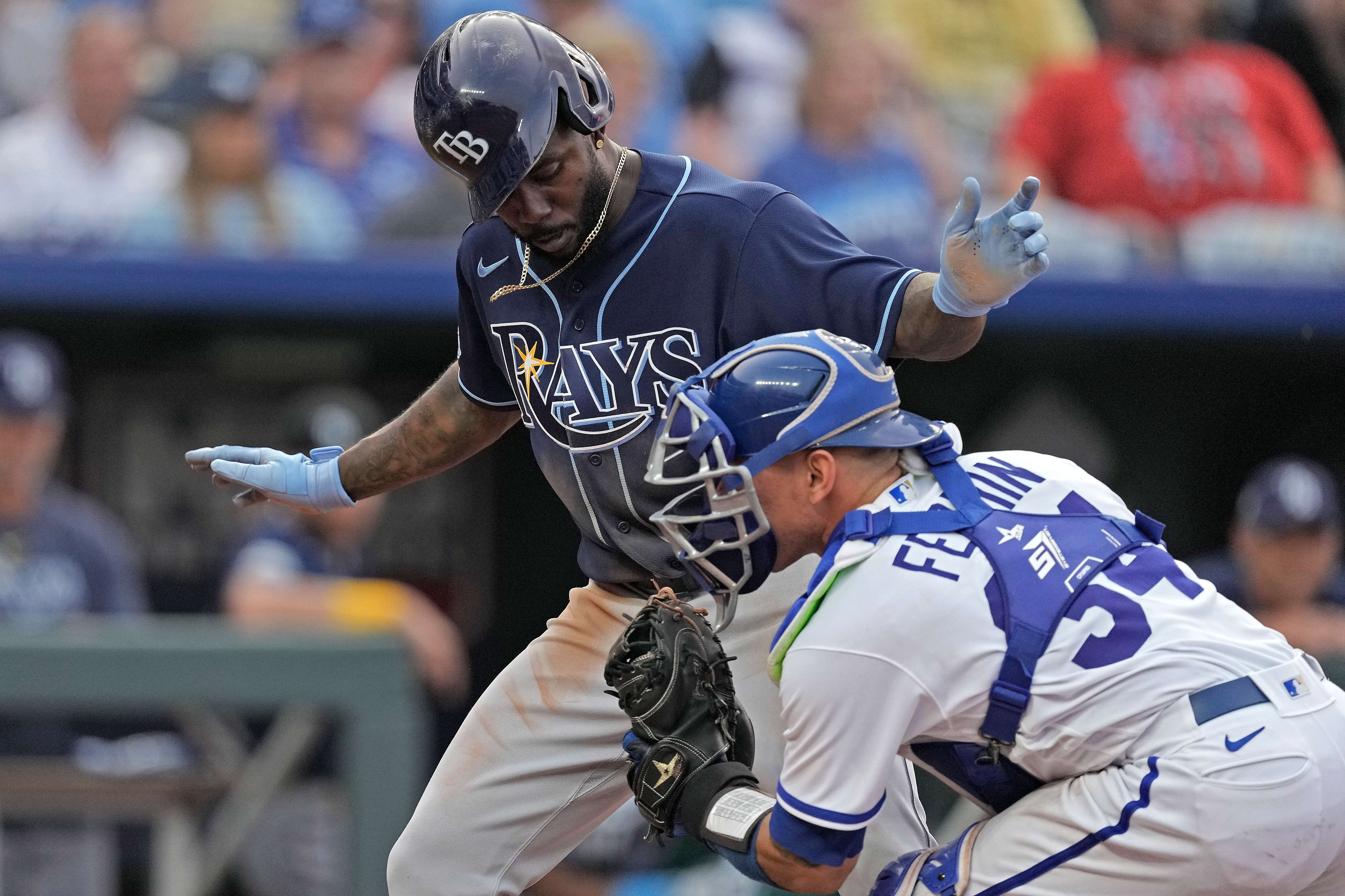 Tampa Bay Rays left fielder Randy Arozaren is tagged out at first by Kansas City Royals relief pitcher Carlos Hernandez as he tried to score on a fielders choice hit by Isaac Paredes during the sixth inning in the second game of a baseball doubleheader Saturday, July 15, 2023, in Kansas City, Mo. (AP Photo/Charlie Riedel)