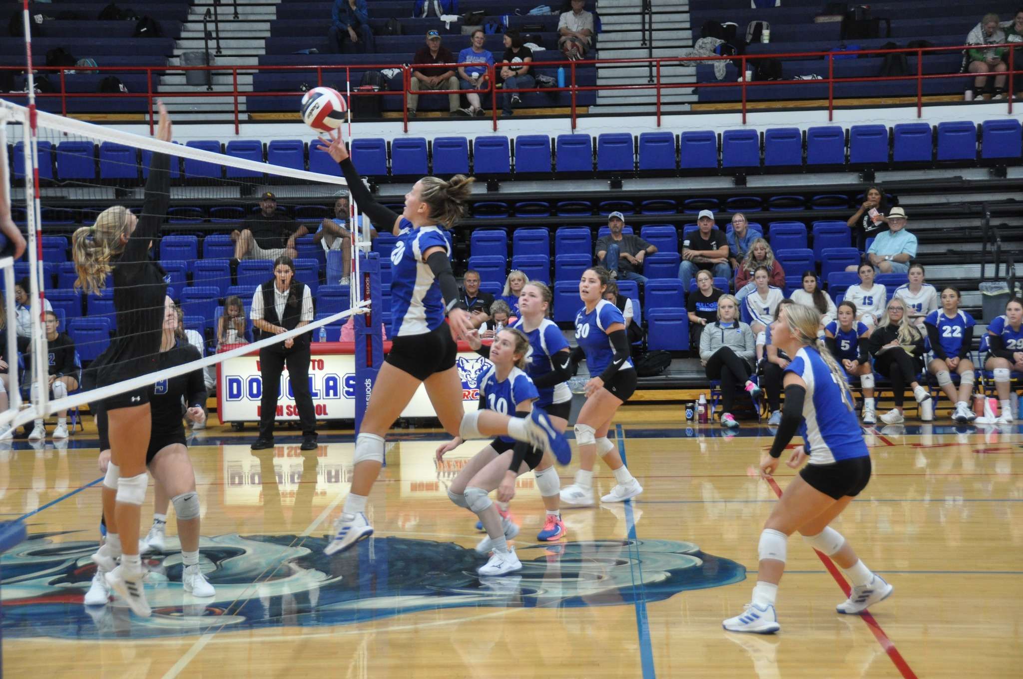 Jaelynne Clarke tips it over the net in a game in Wyoming