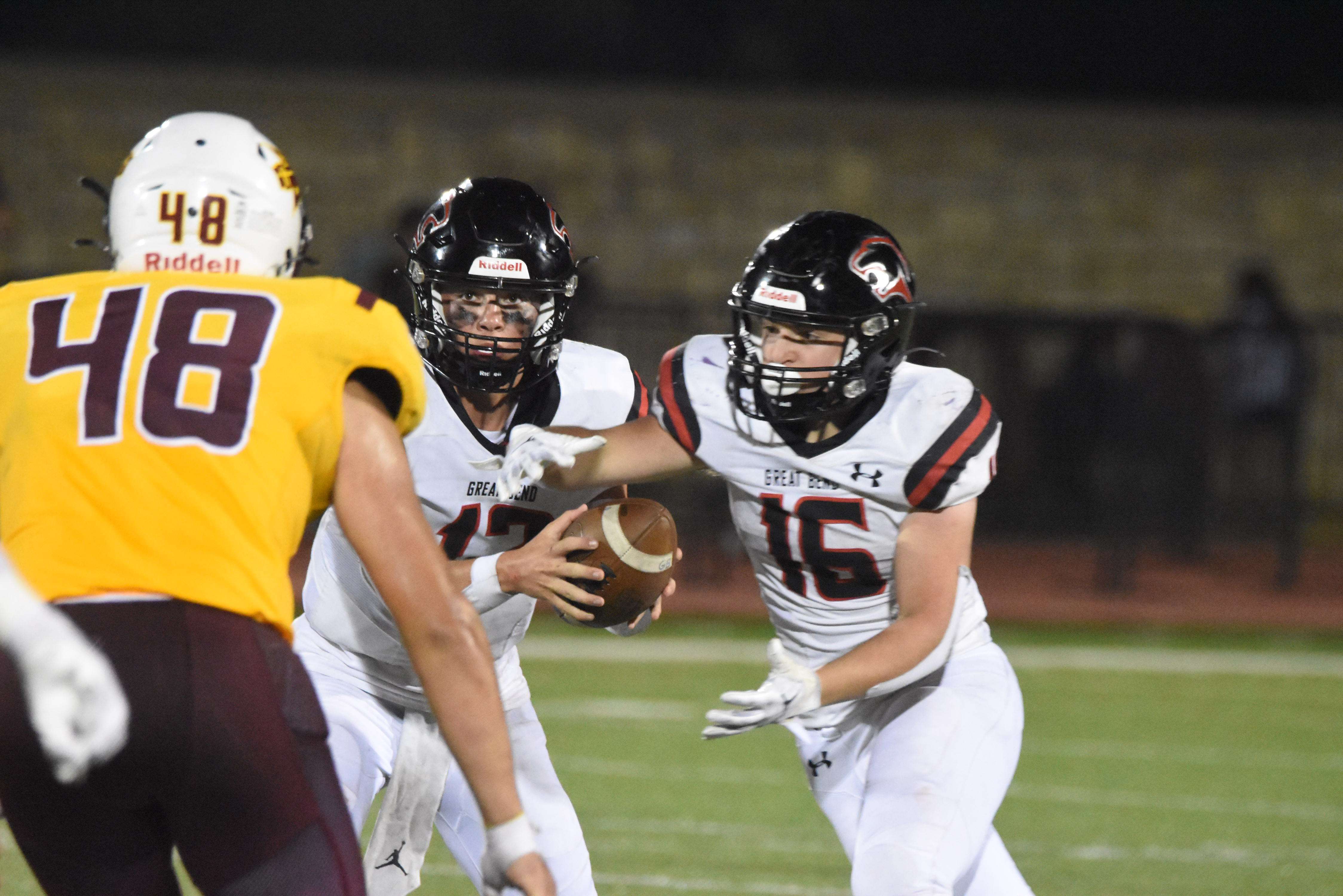 Daxton Minton hands the ball to Cody Miller during the second half of Friday's 28-27 loss to Hays.