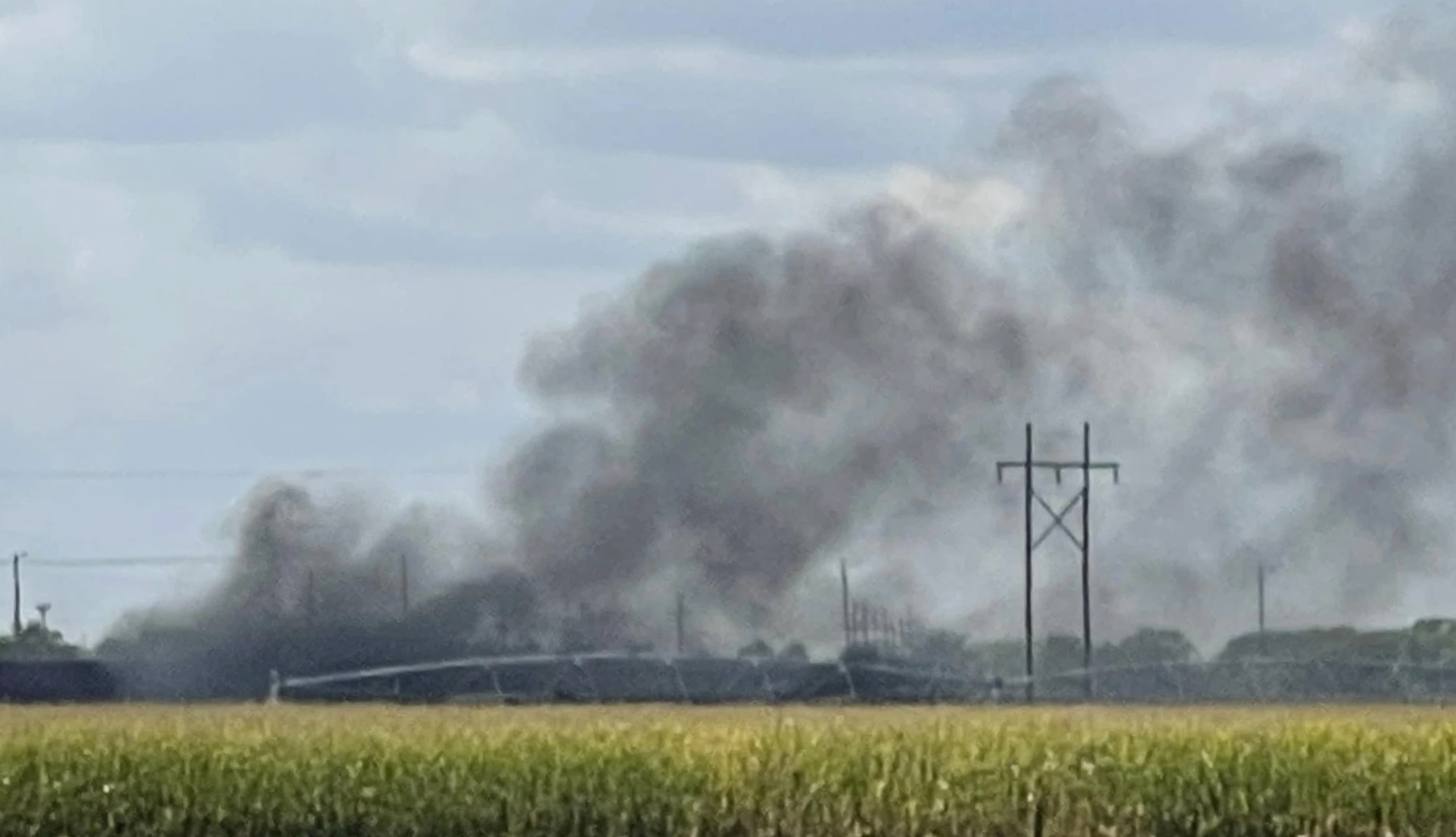 Smoke over the rail yard Thursday-photo by Melanie Standiford/Midwest Media via AP