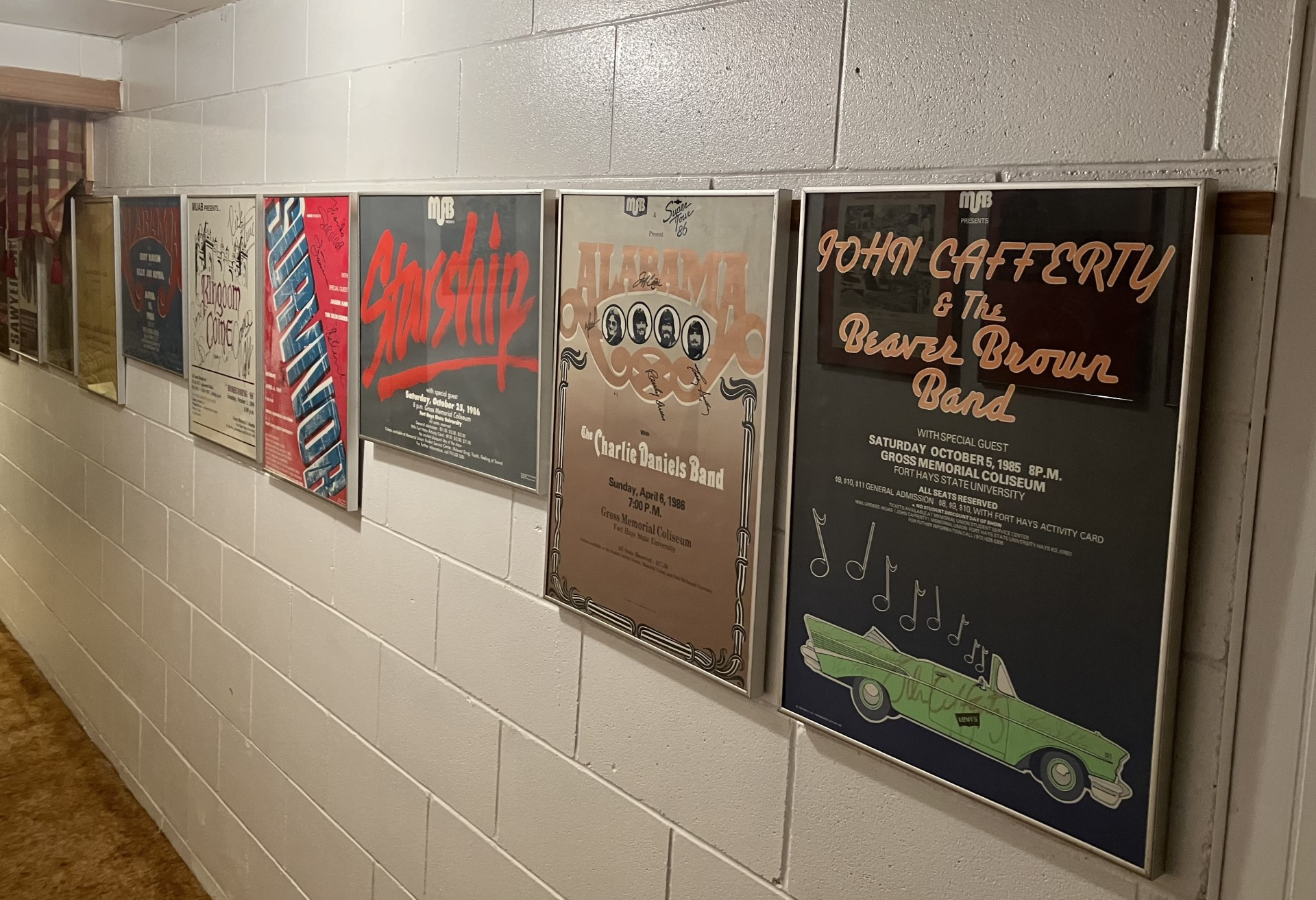 Autographed posters of rock bands that I.B. Dent helped bring to Fort Hays State University line the basement walls of his Hays home. Photo by Randy Gonzales/Special to the Hays Post