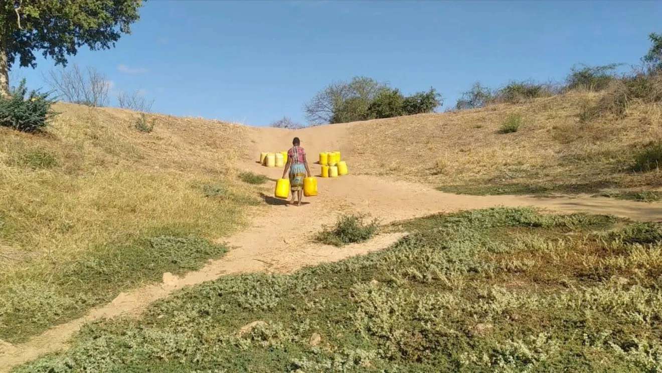 A Kakindu Village woman walking back to the town with water. Courtesy Benjamin Musyoki