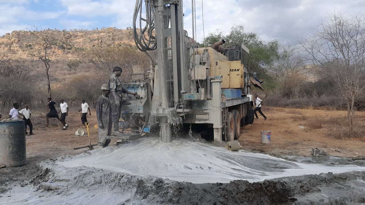 Drillers work on the second well next to the Mikangooni Secondary School as students watch from a safe distance on Aug. 30, 2023, in Kakindu Village, Kenya. Courtesy Benjamin Musyoki