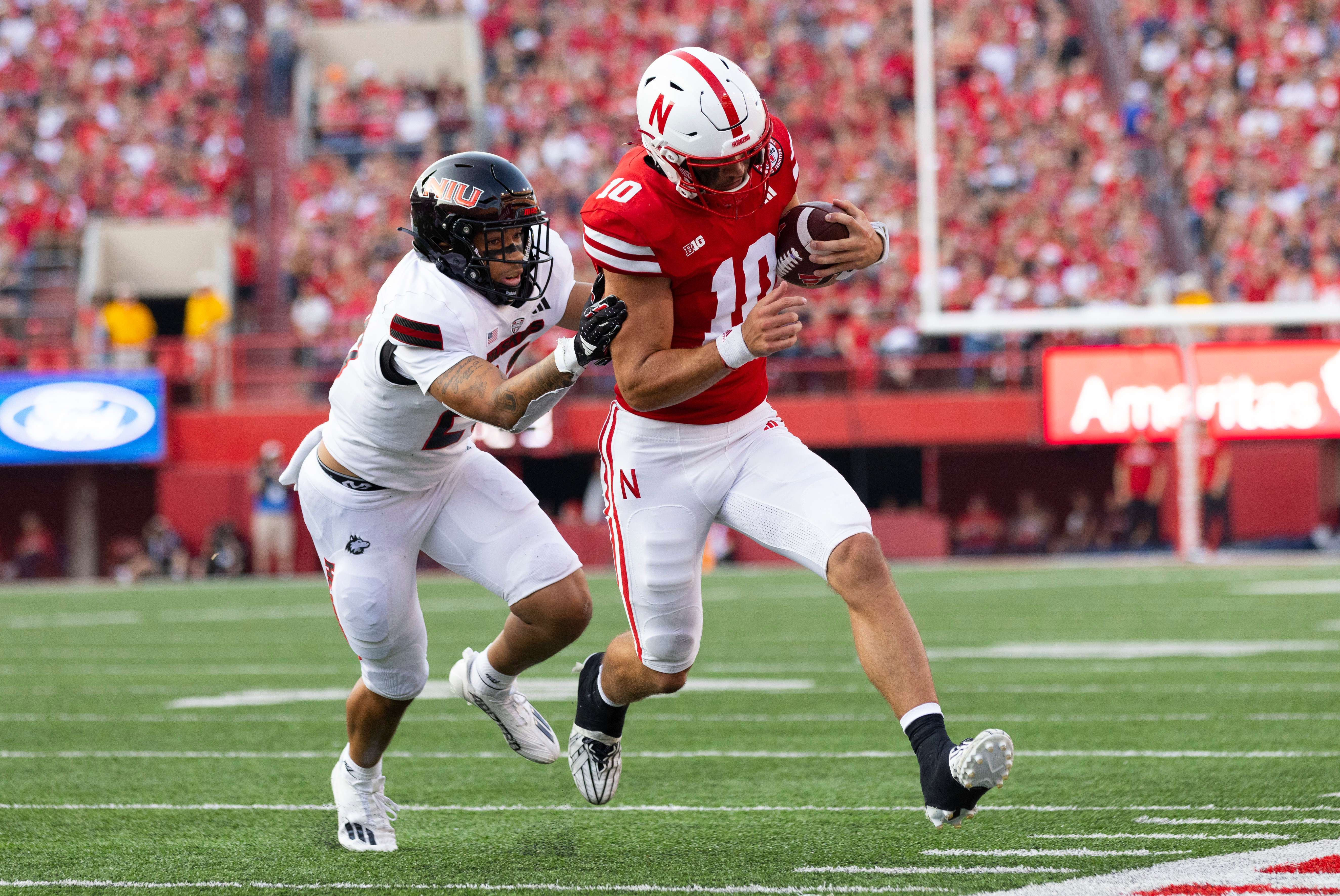 Northern Illinois' DaRon Gilbert, left, chases Nebraska quarterback Heinrich Haarberg out of bounds during the first half of an NCAA college football game, Saturday, Sept. 16, 2023, in Lincoln, Neb. (AP Photo/Rebecca S. Gratz)