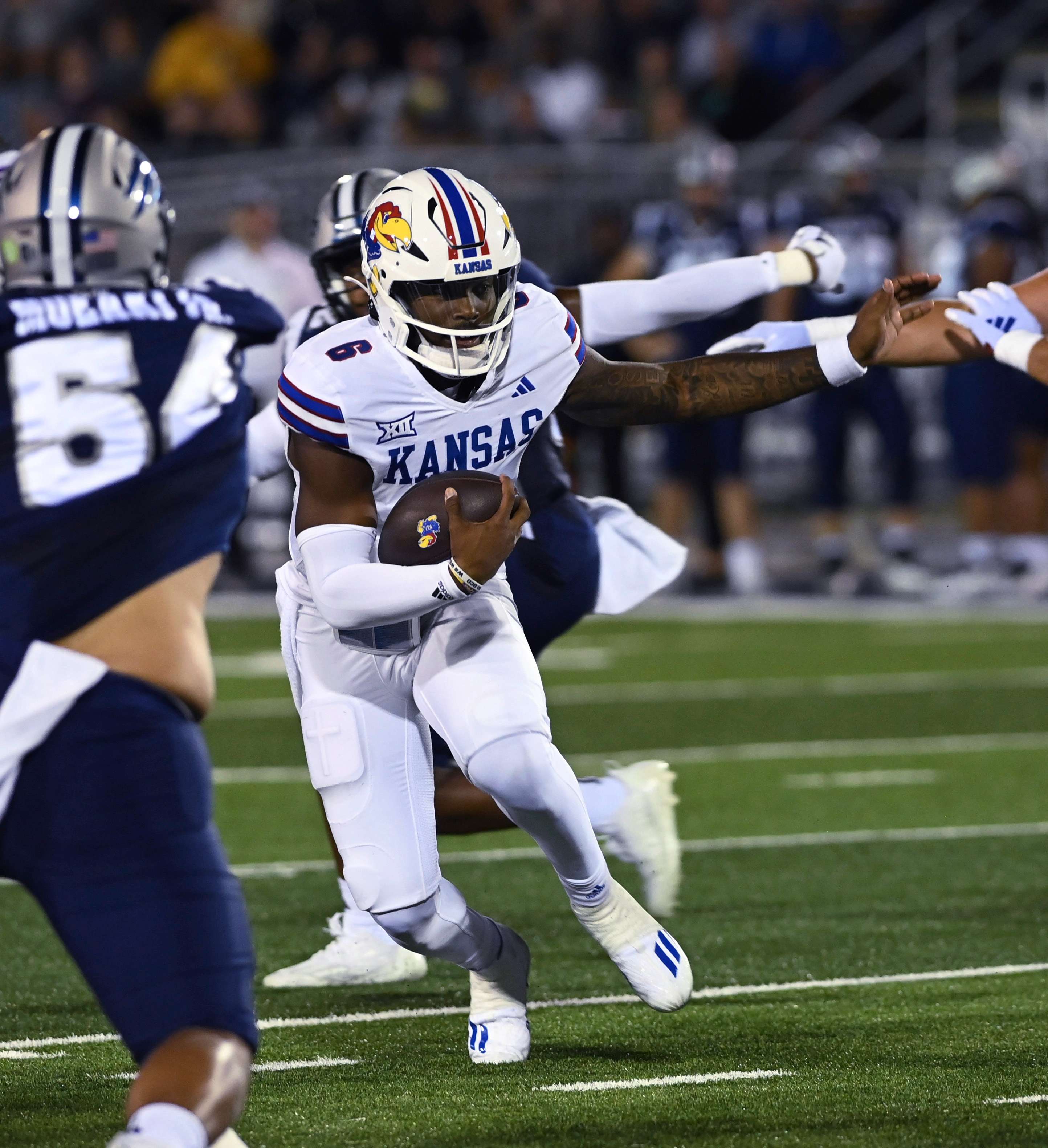 Kansas quarterback runs with the ball against Nevada during the first half of an NCAA college football game Saturday, Sept. 16, 2023 in Reno Nev. (AP Photo/Andy Barron)