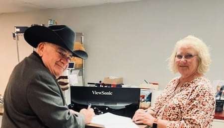 Barton County Sheriff Brian Bellendir files for the 2024 election with the help of County Clerk Bev Schmeidler.