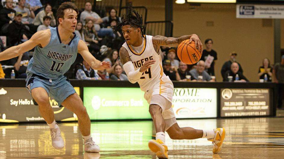 Fort Hays State guard Jahiem Holden (24) dribbles past Washburn's Sam Ungashick (10) in the second half of an NCAA college basketball game on Thursday, January 25, 2024 in Hays, Kan. (FHSU Athletics photo/Nicole Heitmann)