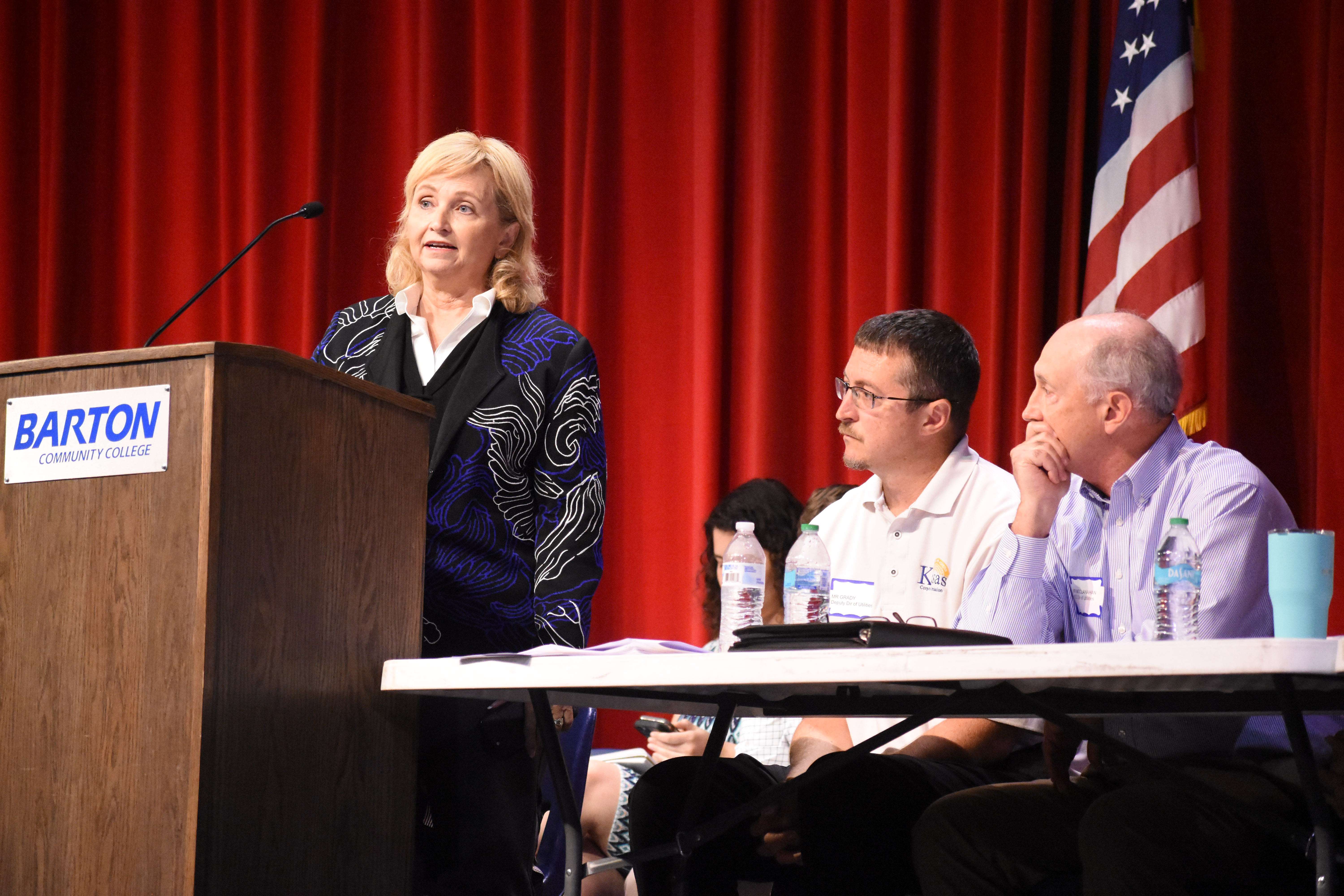 Kansas Corporation Commission's Justin Grady and Jeff McClanahan listen to comments from Sen. Caryn Tyson during Tuesday's tri-county meeting at Barton Community College.