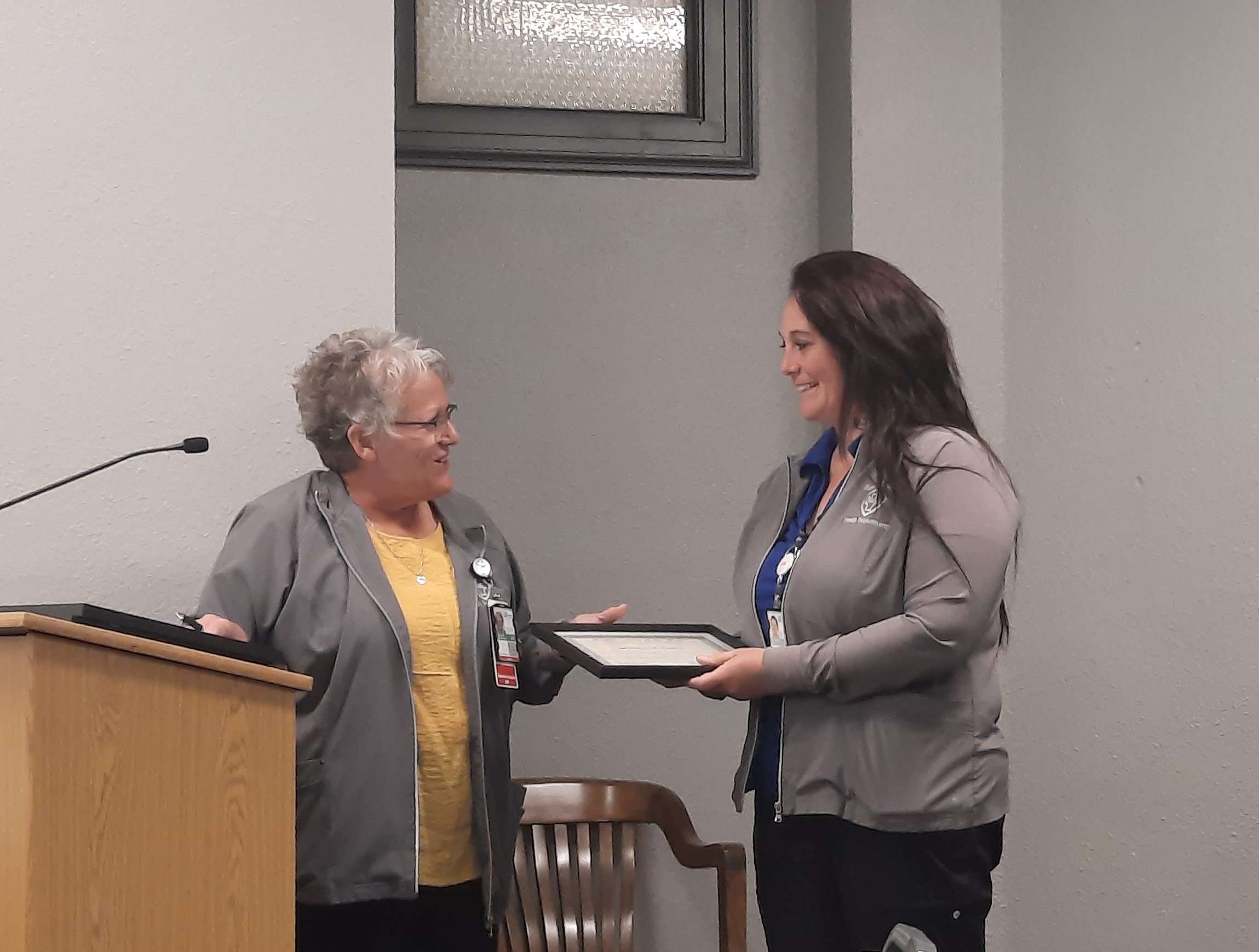 Barton County Health Department Director Karen Winkelman hands Savannah Bochy a certificate during Tuesday's county commission meeting. Bochy was recently named Maternal Child and Health Home Visitor of the Year by the Kansas Dept. of Health and Environment.