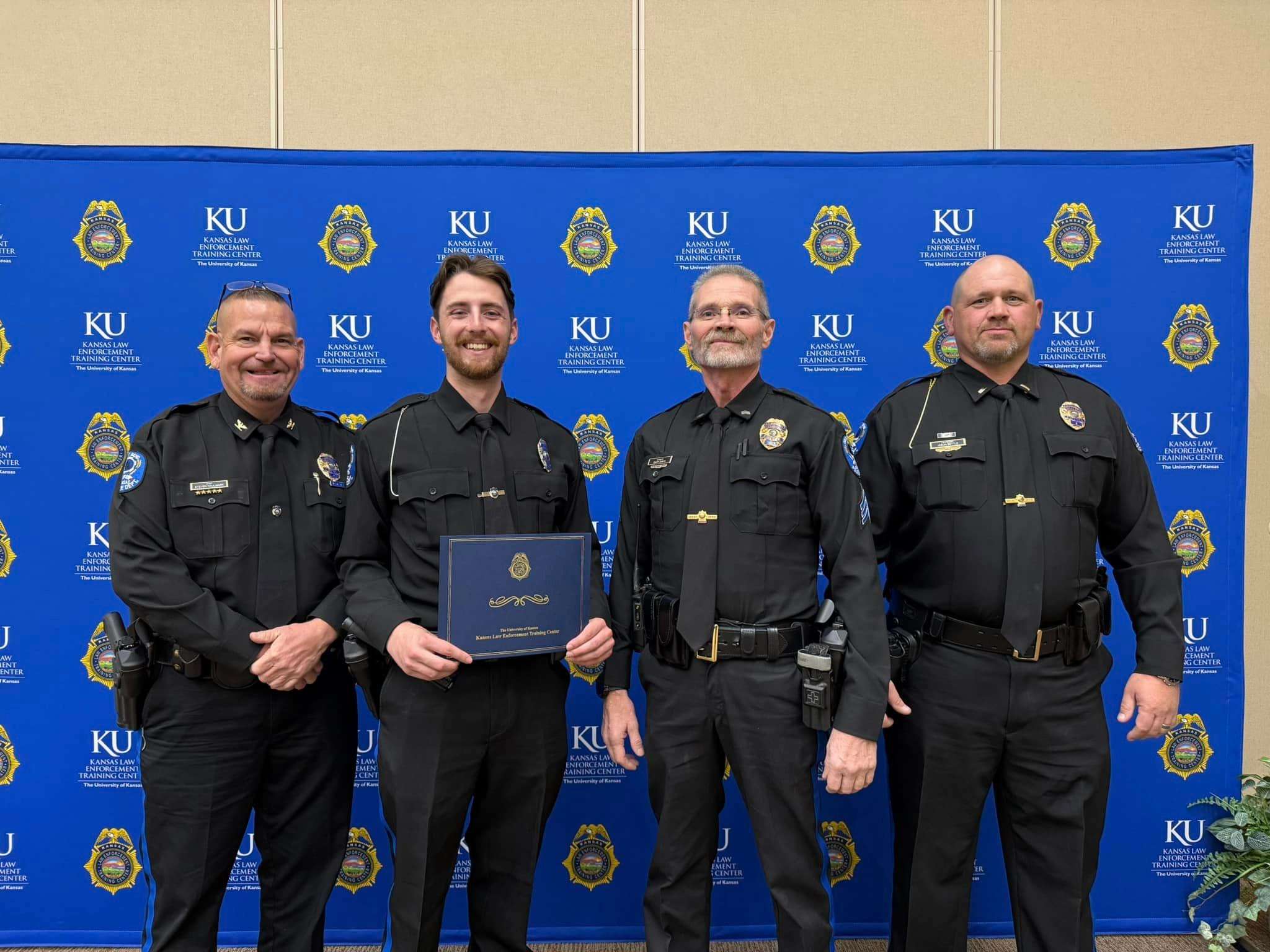 Garrett Dykes (second from the left) is pictured with Great Bend Police Chief Steve Haulmark, Sergeant Gary Davis and Lieutenant Jason Settle. Dykes graduated from basic training and was awarded the Academic Excellence award.
