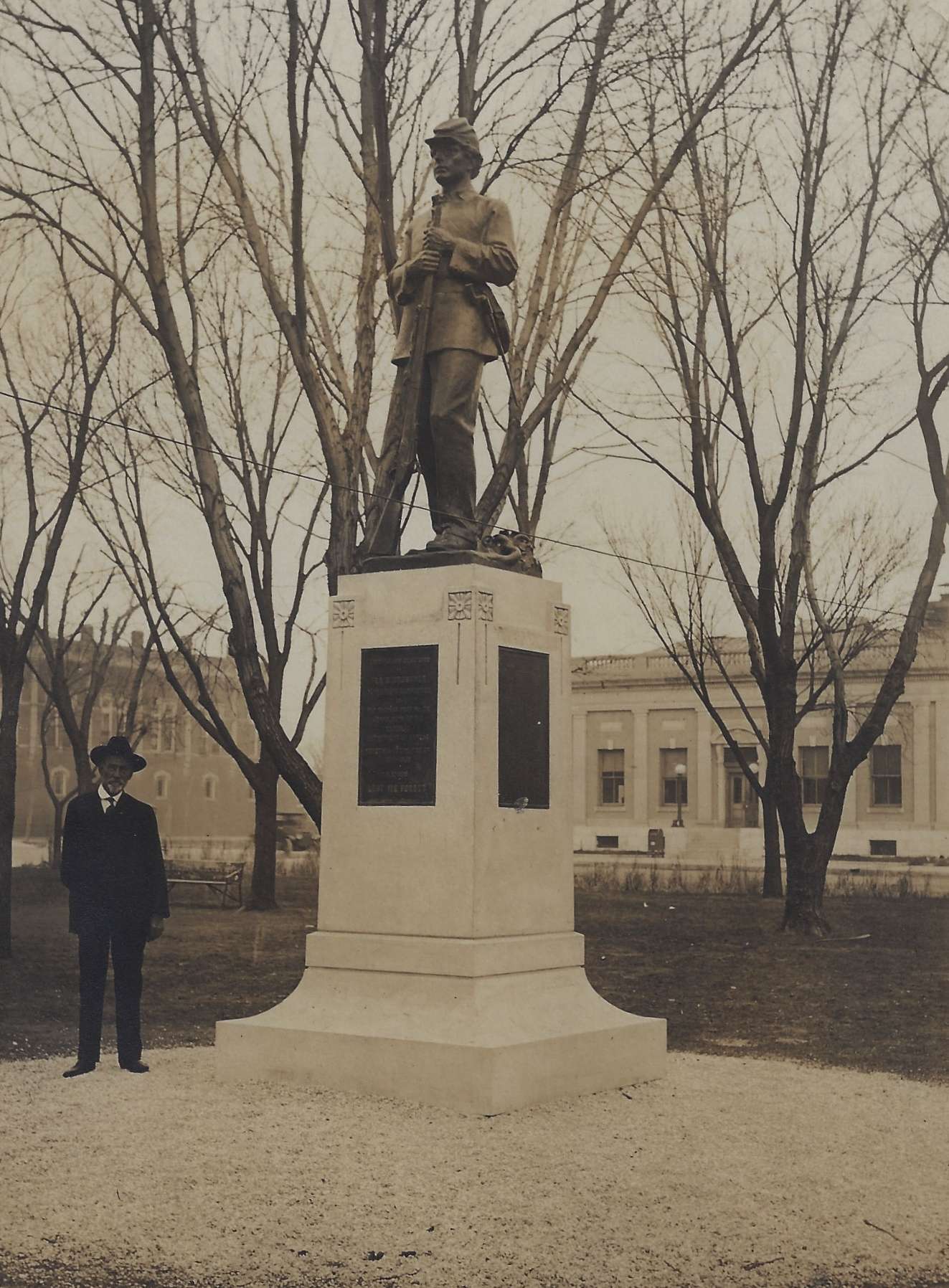 Ira Brougher standing next to "The Rifleman" statue that was dedicated in 1915 next to the Barton County Courthouse in Great Bend. (Photo courtesy of the Frederick Hibbard family estate)