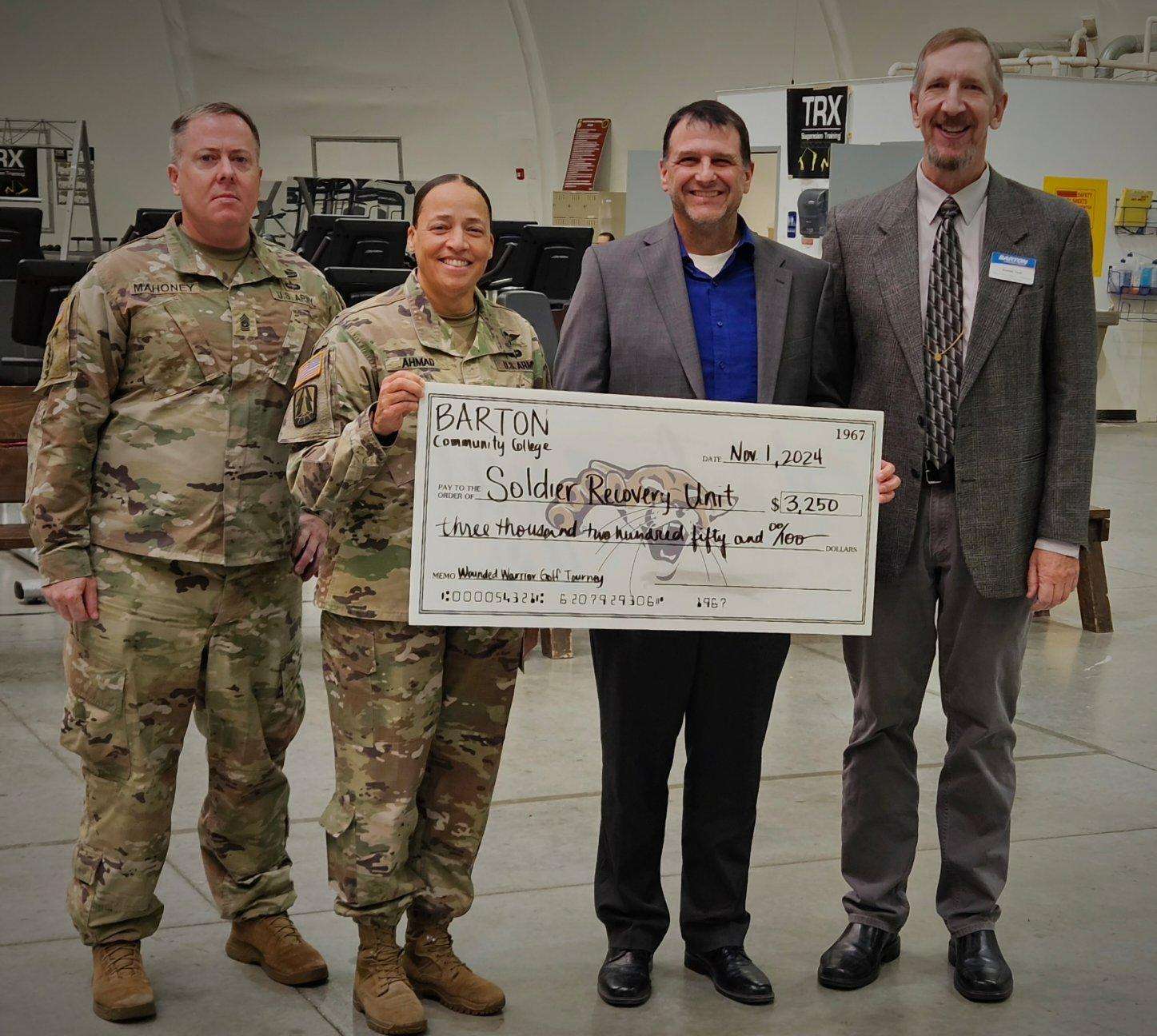 (From left) Fort Riley Soldier Recovery Unit Leadership, Command Sergeant Major Joseph Mahoney, and Lieutenant Colonel Yolanda Ahmad receive a check for $3,250 from Barton President Dr. Marcus Garstecki and Dean of Military Academics, Technical Education, and Outreach Programs Kurt Teal. The funds were raised through the annual Wounded Warrior Golf Scramble.