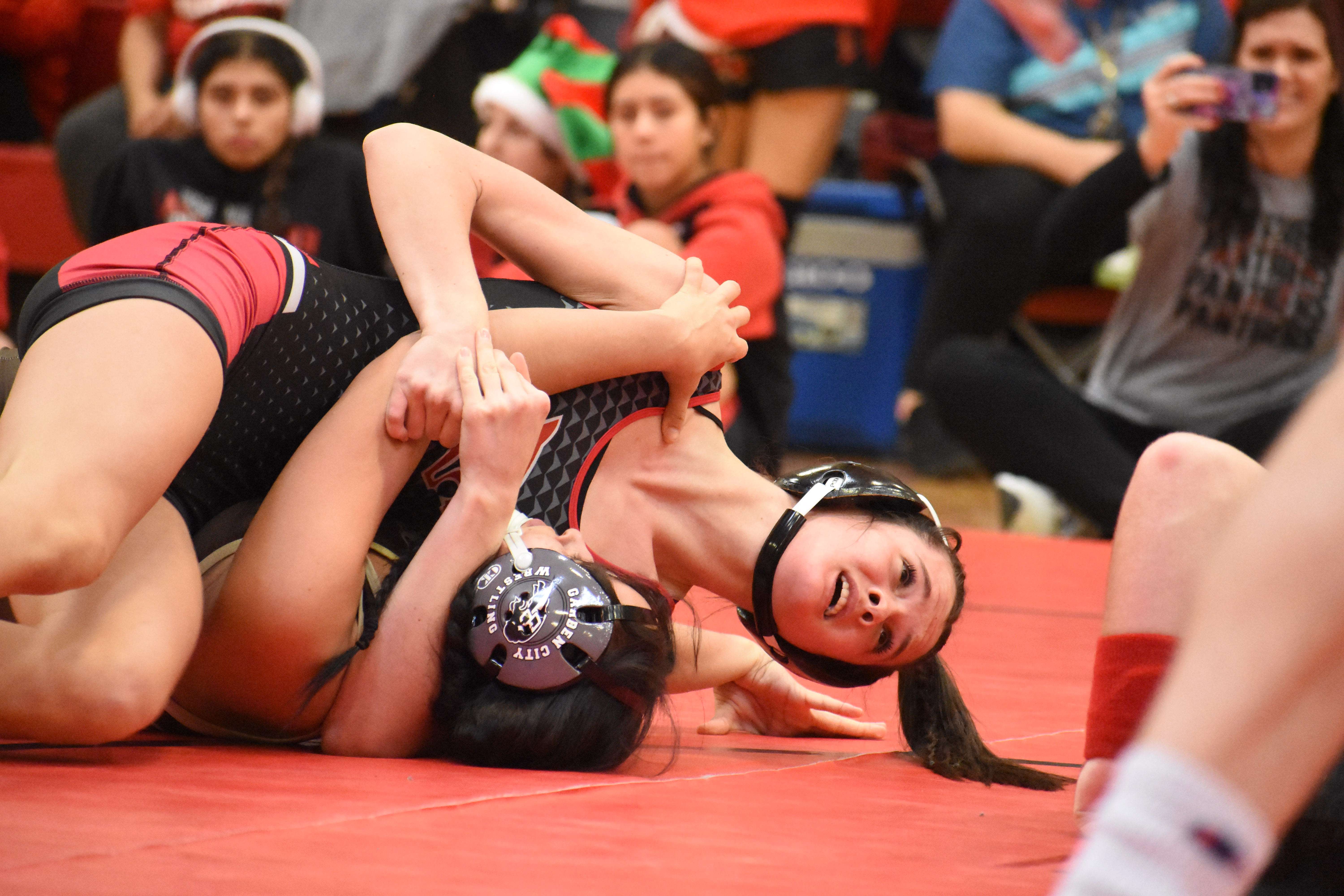 Great Bend freshman Micah Ellegood nearly pinned but was later defeated by Garden City's reigning state champion Maya Tarbet.