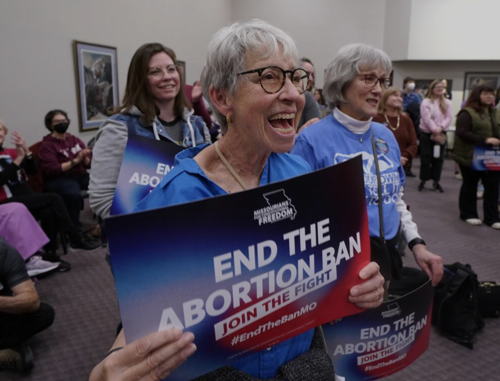 Pam Scovill, center, reacts to a speaker during Missourians for Constitutionals Freedom kick-off petition drive, Tuesday, Feb. 6, 2024, in Kansas City, Mo. Missouri senators on Wednesday, Feb. 7, 2024, voted against amending the state's strict law against abortions to allow exceptions in cases of rape and incest. (AP Photo/Ed Zurga, File)