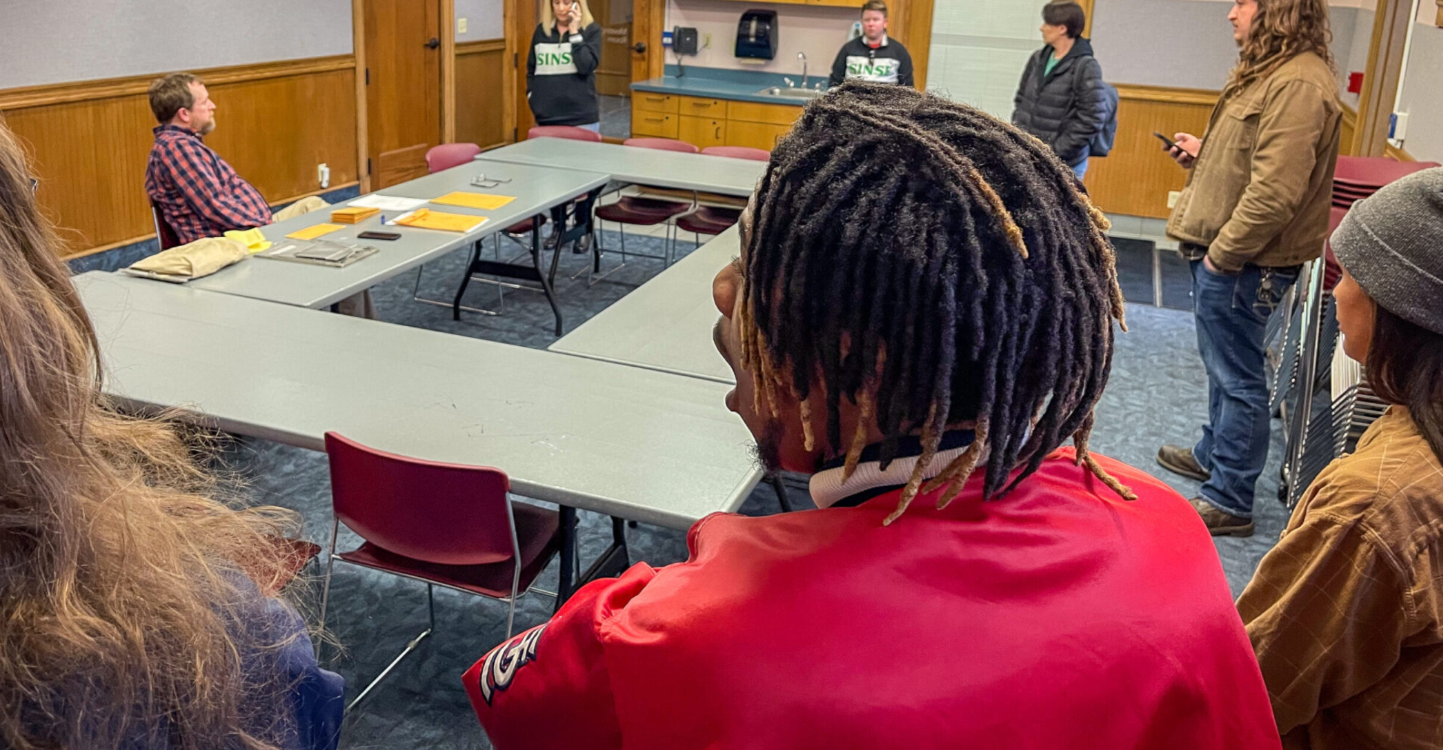 Ahmad Haynes, a post-harvest technician at BeLeaf Medical’s Sinse facility, reacts to the company’s representative announcing the company wants to continue contesting the eligibility of 11 employees to vote in a Feb. 6 election to unionize. The election was held at the St. Louis Public Library Barr branch (Rebecca Rivas/Missouri Independent.)