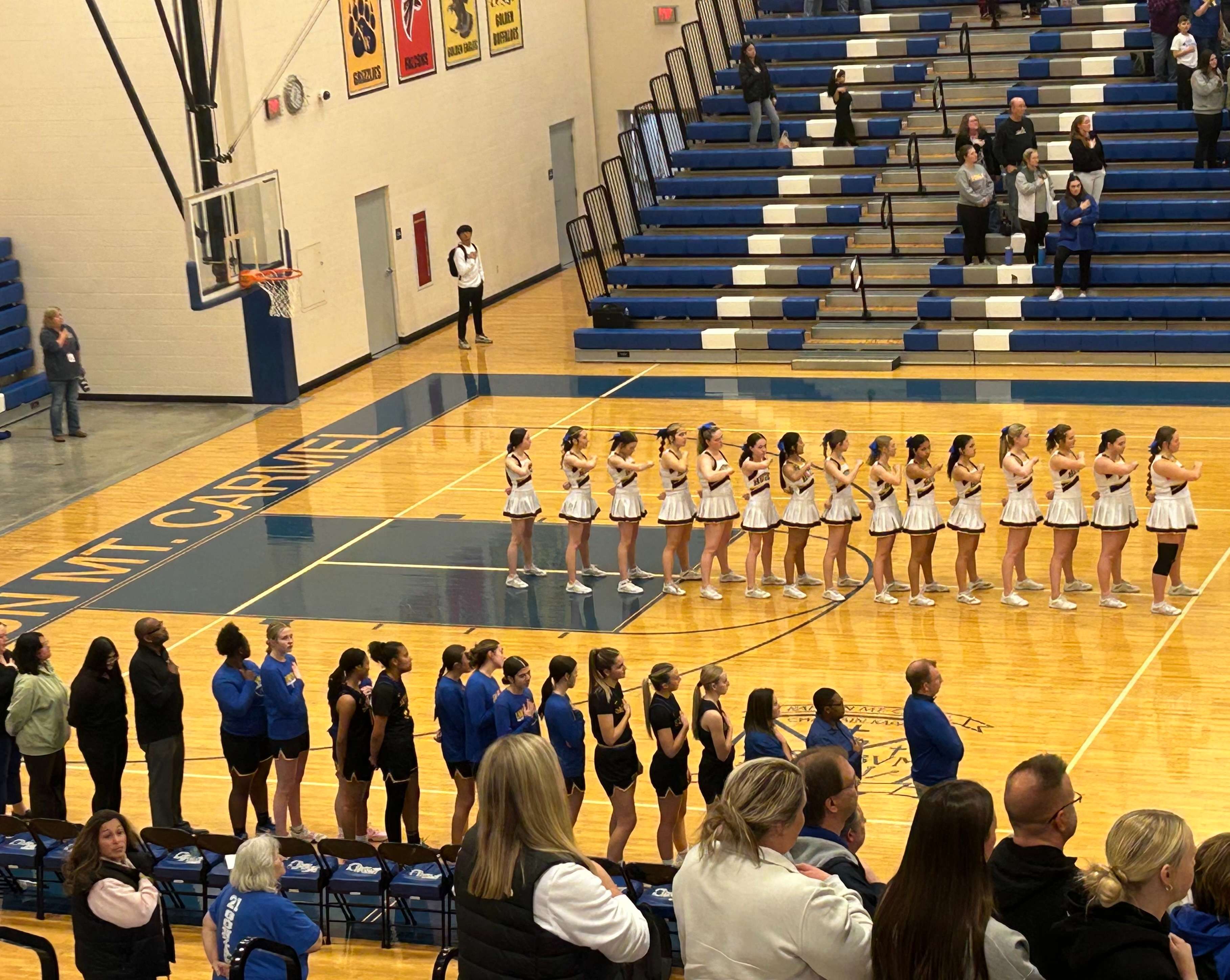 The Hutchinson High School girls basketball team standing during the national anthem prior to tipoff of the first round of the Class 5A Sub-State Girls Basketball Tournament. The Salthawks beat Wichita-Kapaun Mt. Carmel 41-37. 