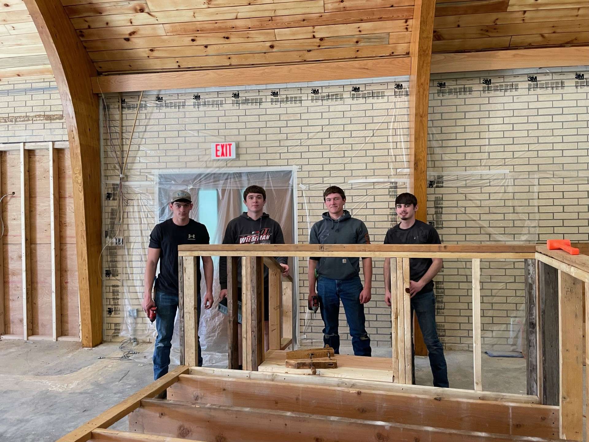 Corbyn Causey, Zach Davis, Caden Guesnier, and Blake Streck with the sound booth they helped construct using used lumber from the First Southern Baptist Church that was damaged during the July 16 storm that swept through Great Bend.