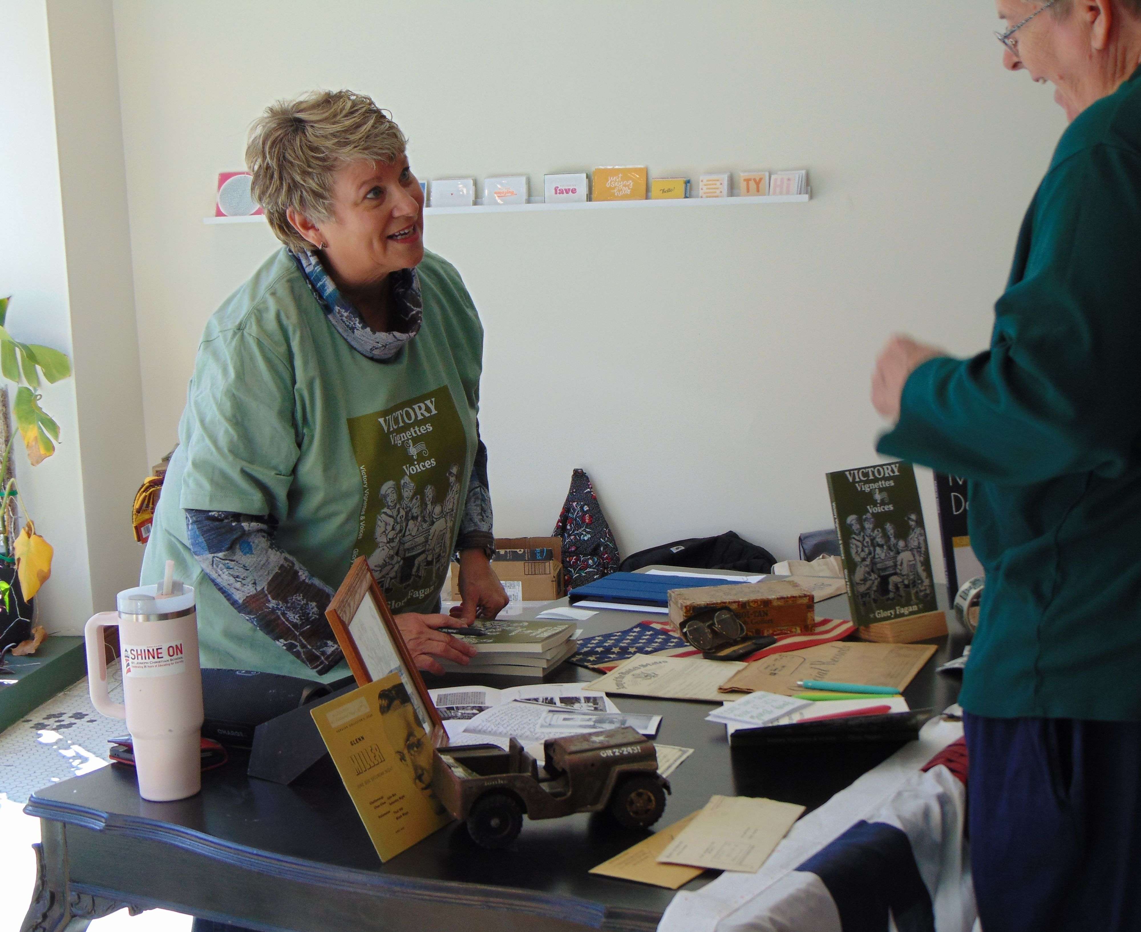 Author Glory Fagan talks with a reader during the book signing at the Story Collective/Photo by Brent Martin