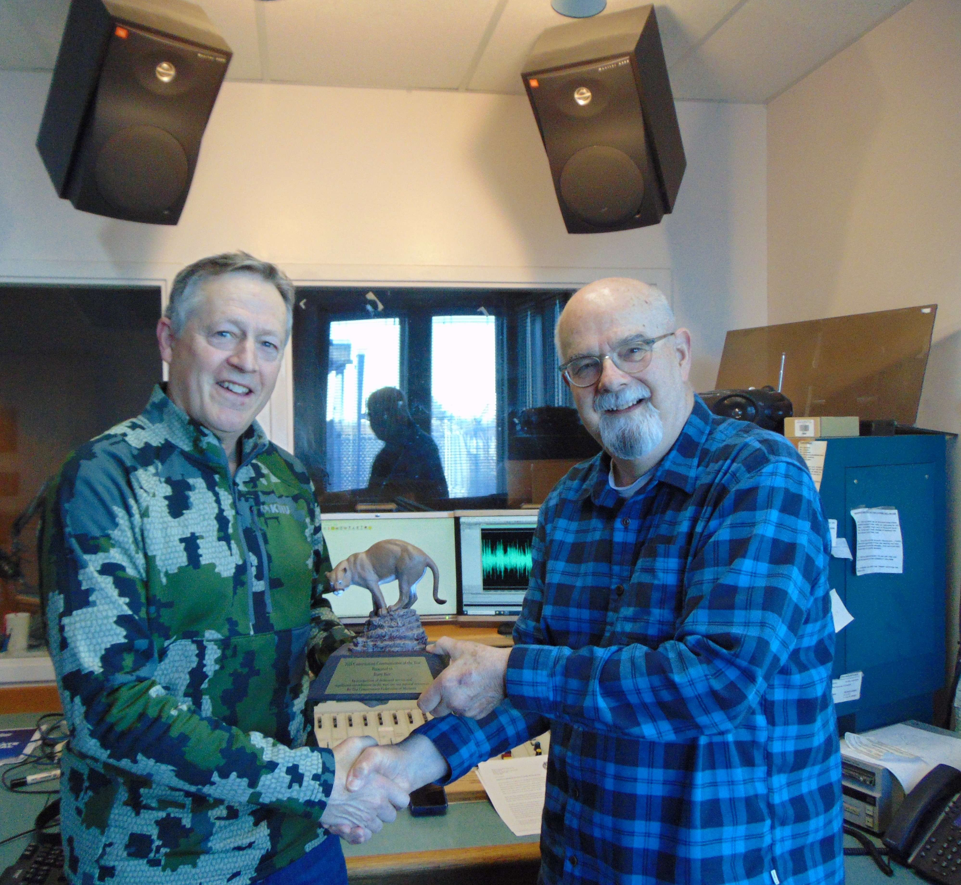 Former Conservation Agent Kyle Carroll (left) presents KFEQ's Barry Birr with the Conservation Communicator of the Year award/Photo by Brent Martin