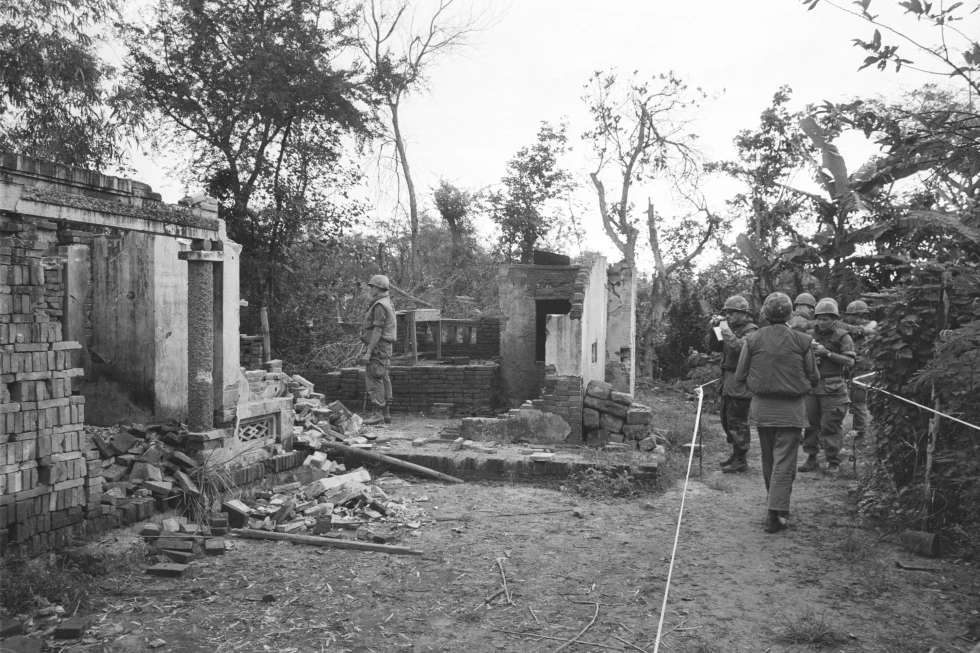 American soldiers look over the remains of a home in My Lai, South Vietnam in this Jan. 8, 1970 file photo. The GIs are in a safe area marked off with white tape, having been swept for booby-traps that have already wounded five soldiers since the investigation of the killing of unarmed civilians by members of the U.S. Army; what would come to be called The My Lai Massacre, began. <b>(AP Photo/File)</b>
