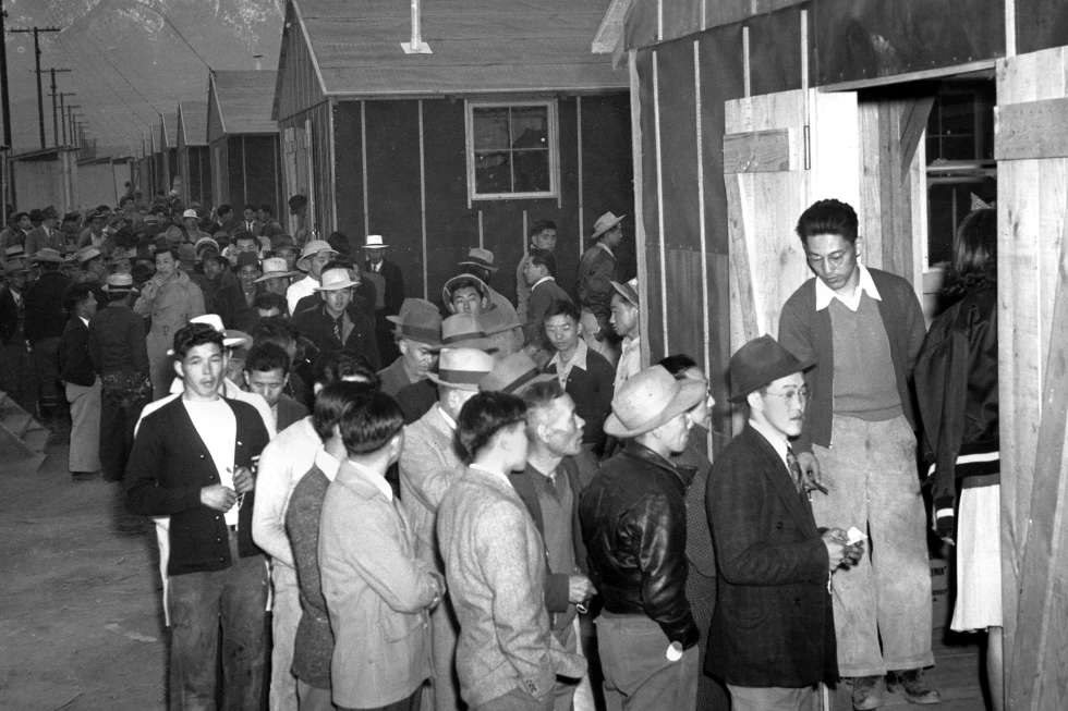 In this March 24, 1942 file photo Japanese citizens wait in line for their assigned homes at an alien reception center in Manzanar, Calif. Many were forced from their homes in Los Angeles by the U.S. Army. <b>(AP Photo, file)</b>
