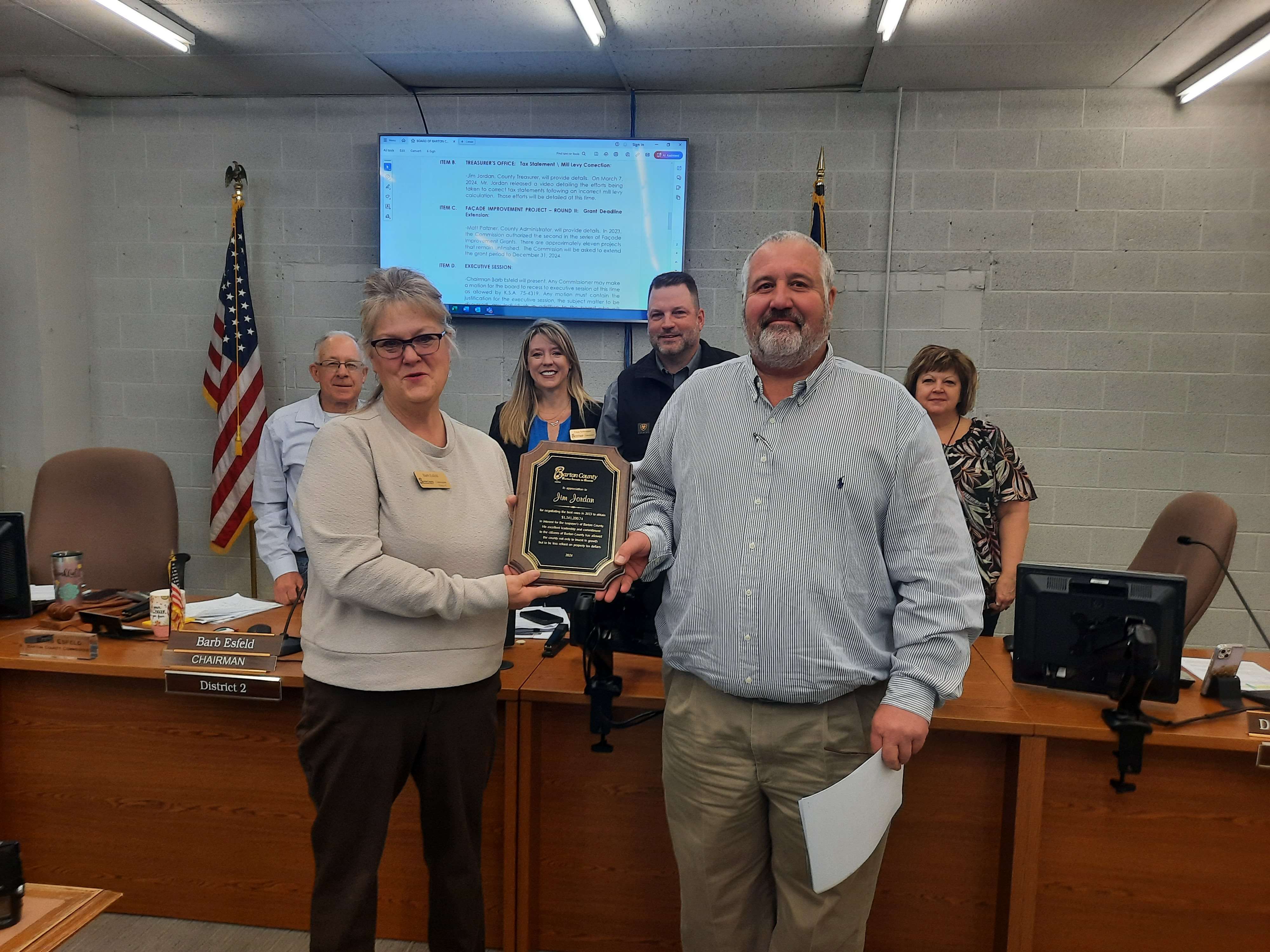 Barton Commission Chair Barb Esfeld presented Treasurer Jim Jordan with a plaque of appreciation for accounting that generated $1.32 million in interest gains last year.