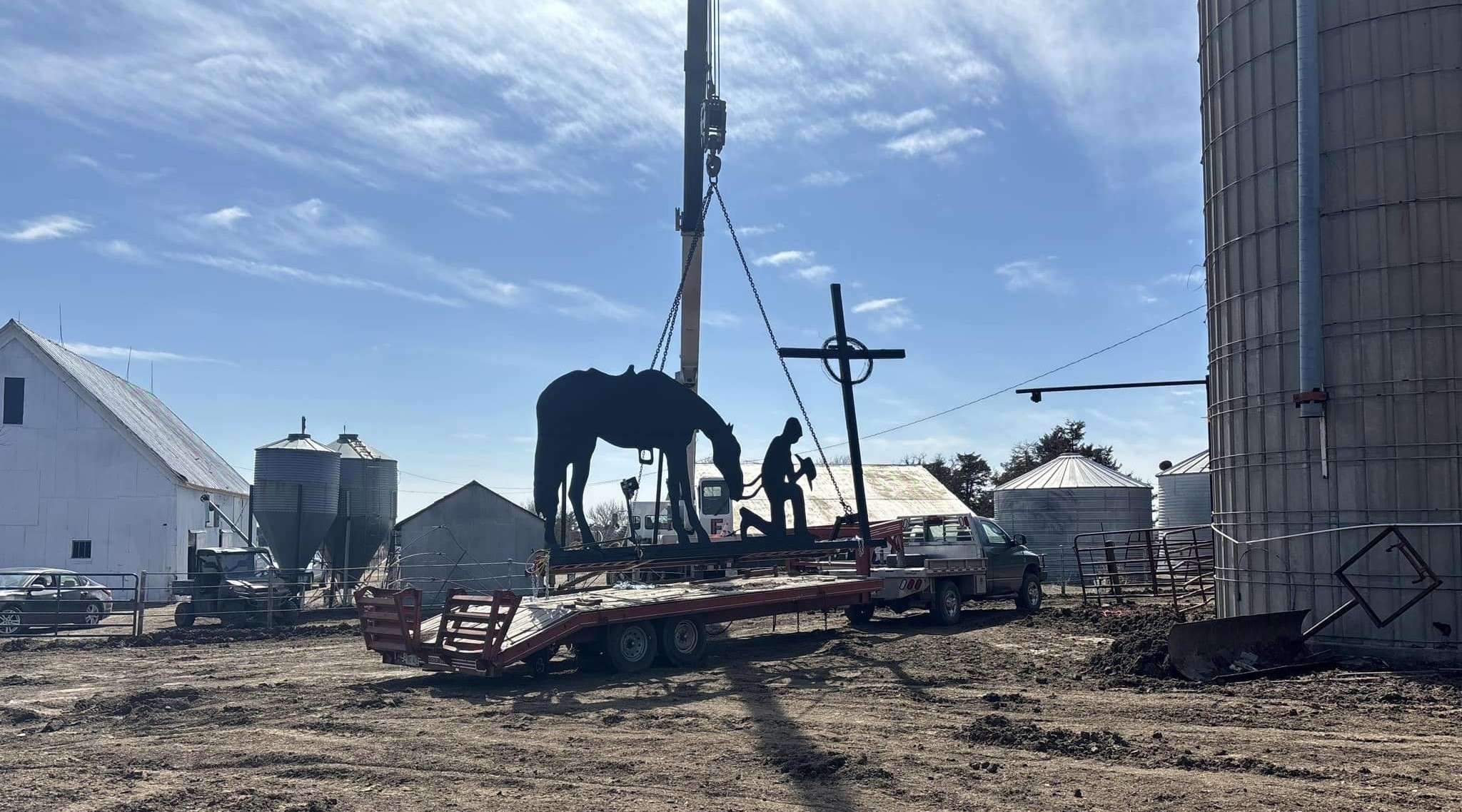 Workers from Farley Machine Works Company recently installed a handmade monument atop a silo on the Mark Hlavaty farm near Olmitz.