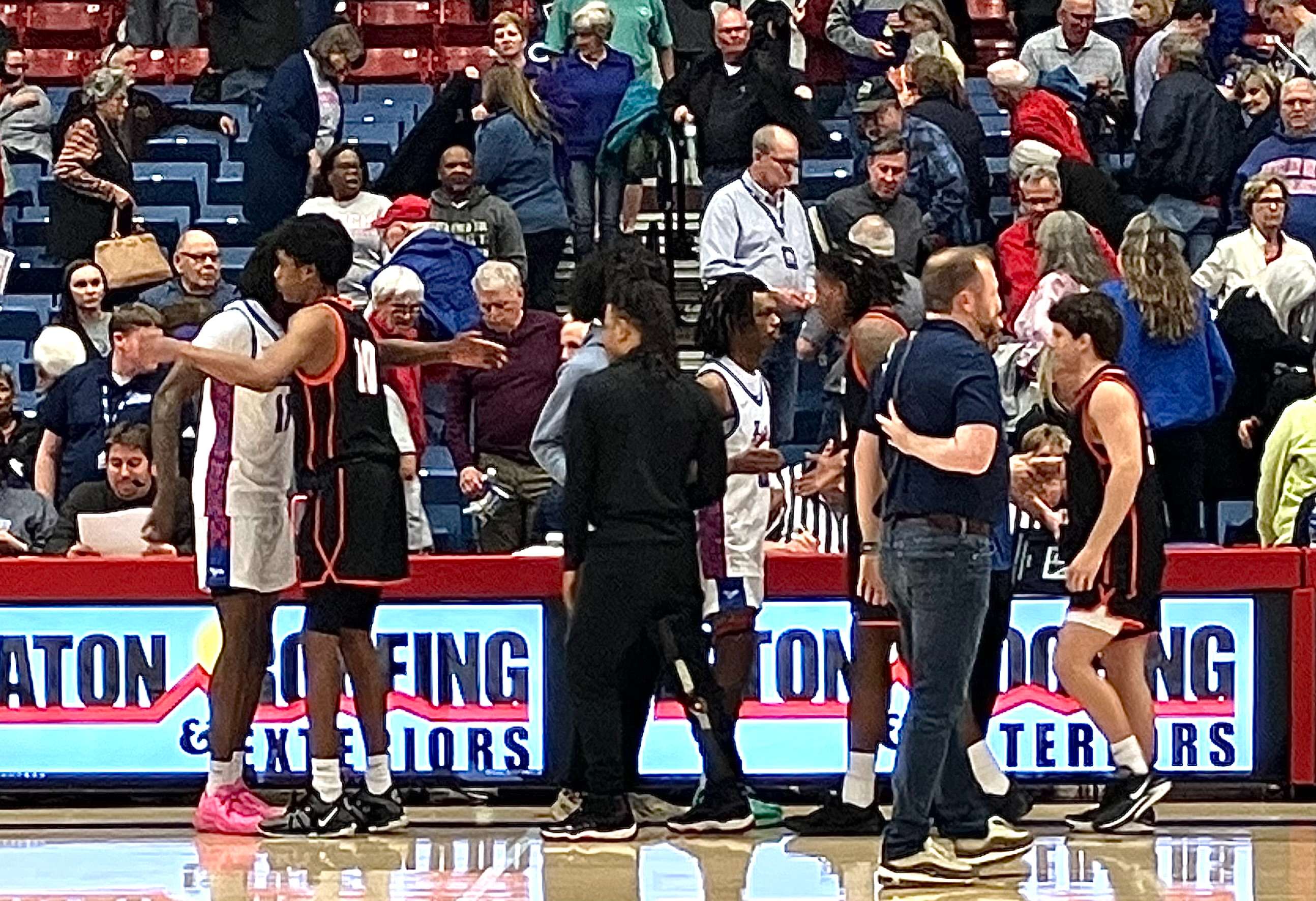 Sophomore guard Antonio Green Jr. who played for Hutchinson before transferring to Connors State hugs sophomore guard Dadrevious Weathers. Hutch lost to Connors State 91-69 in the semifinals of the 2024 NJCAA Division I Men's Basketball Championship on Wednesday, March 27, 2024. Photo by Emmie Boese.