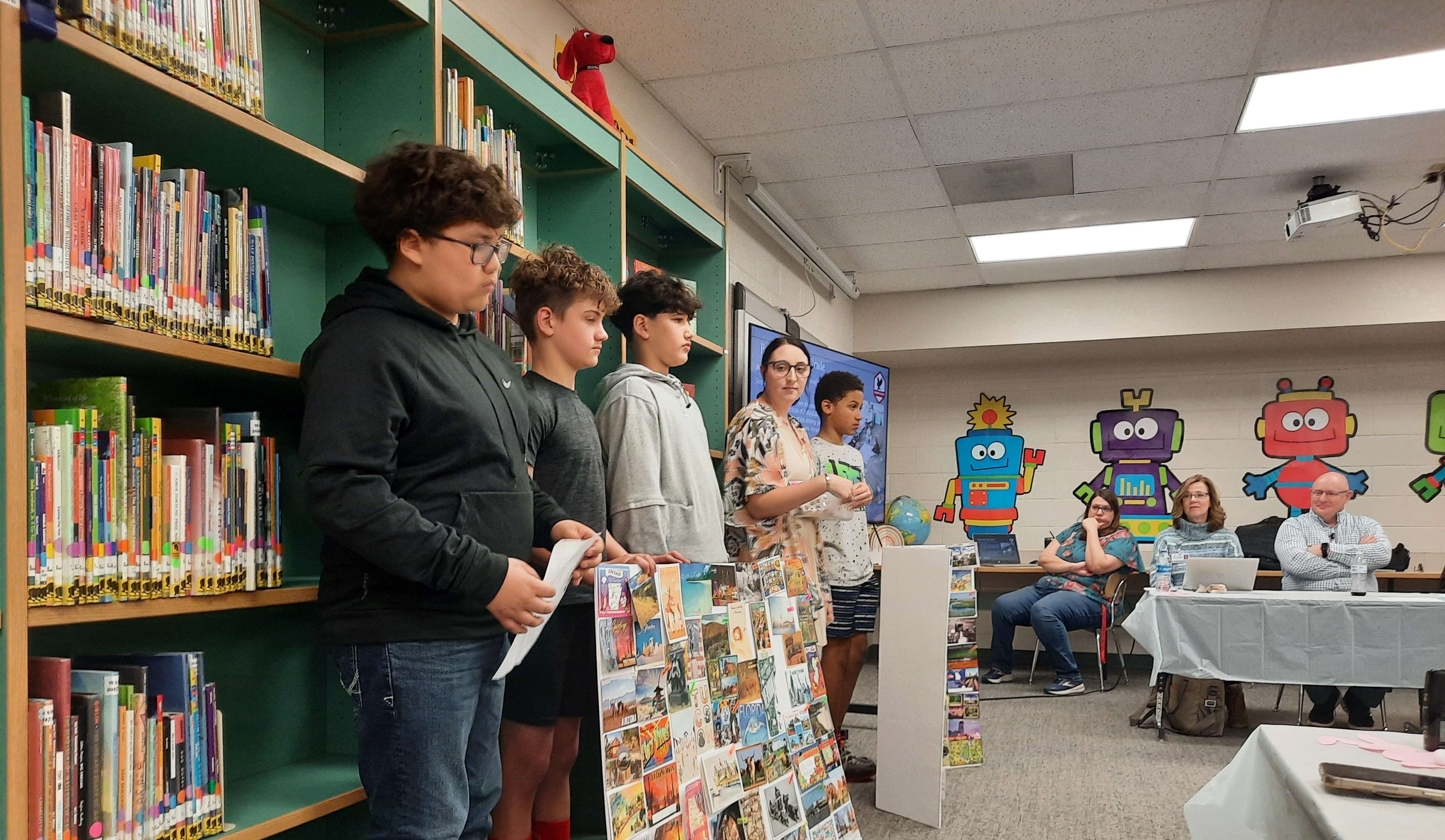 Students from Brooke Reif's sixth-grade class at Eisenhower Elementary show off postcards from all 50 states and seven countries during last Wednesday's USD 428 Board of Education Luncheon.