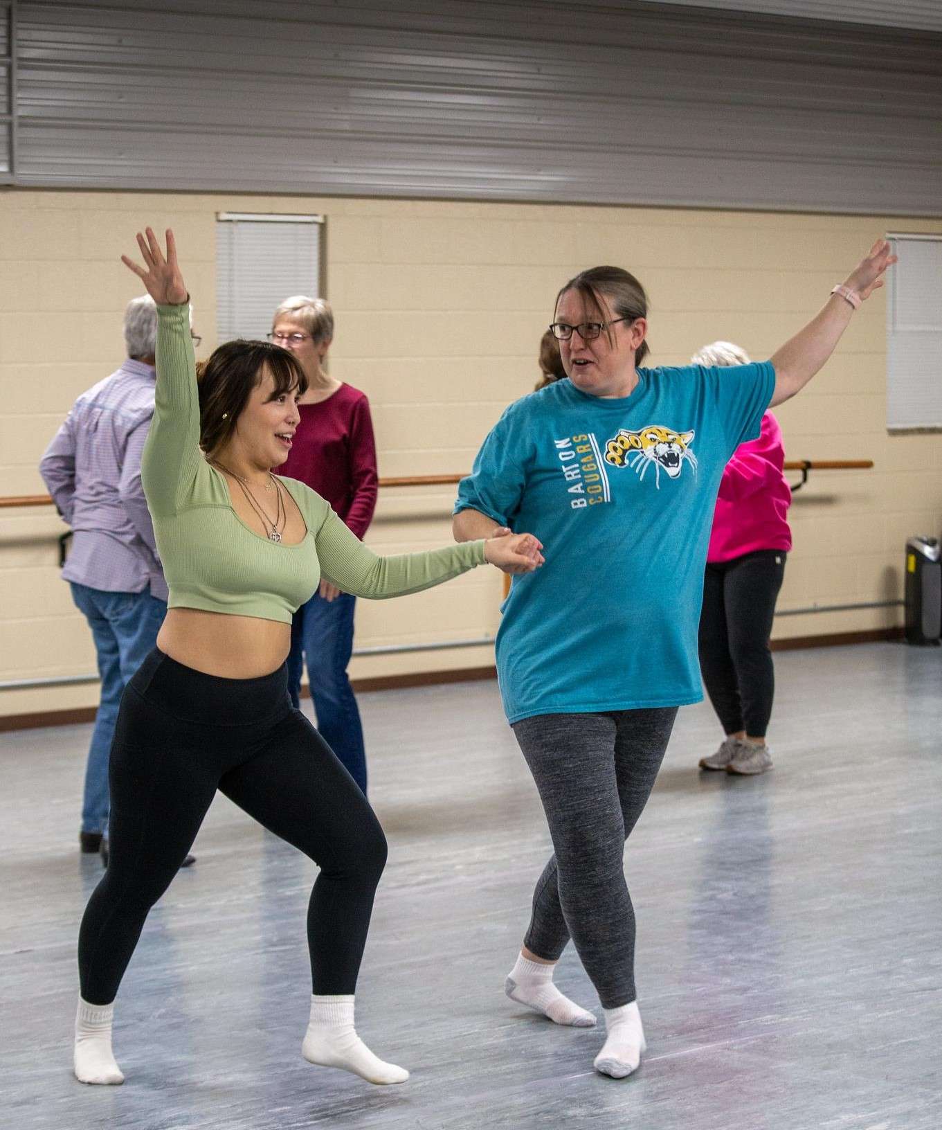 (From left) Rylee Ayon assists at a “Dancing with the Cougars” event last year as she dances with Erin Dannebohm.