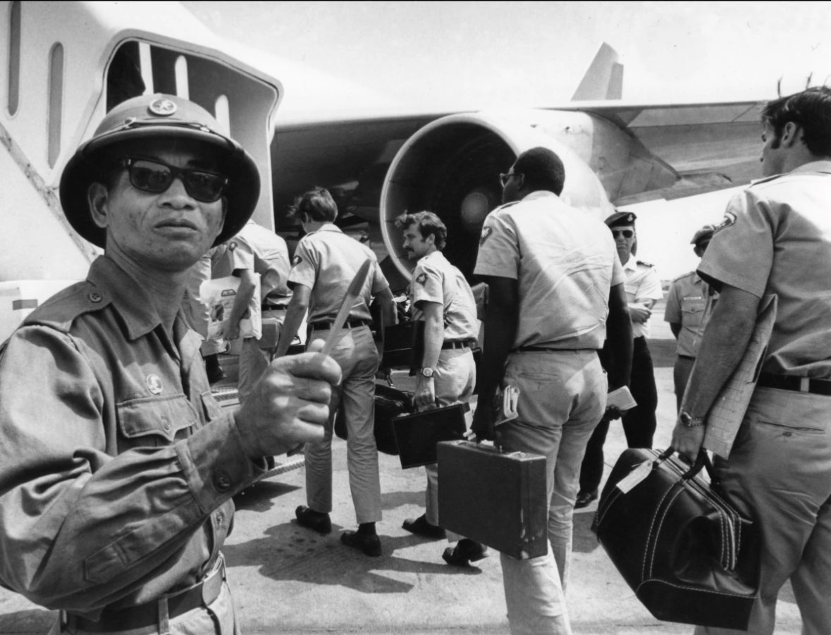 A Viet Cong observer of the Four Party Joint Military Commission counts U.S. troops as they prepare to board jet aircraft at Saigonís Tan Son Nhut airport, March 28, 1973. Nineteen planeloads of U.S. personnel left Vietnam as the withdrawal of American troops drew to a close according to the provisions of the Paris Accords. (AP Photo/Neal Ulevich)<br>