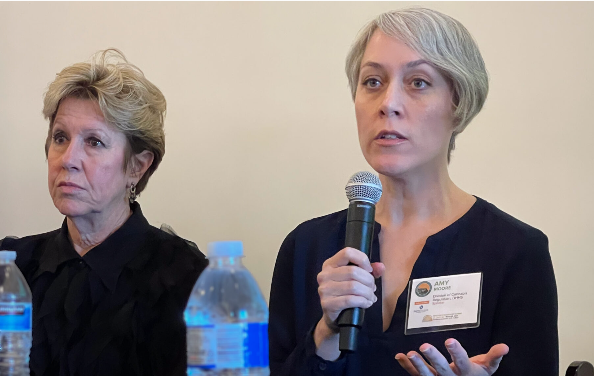  Amy Moore, (right) director of the Missouri Division of Cannabis Regulation, speaks at the National Cannabis Industry Association’s summit on March 28, 2024 in St. Louis. At left is Mitch Meyers, partner at BeLeaf Medical marijuana company. (Rebecca Rivas/Missouri Independent).