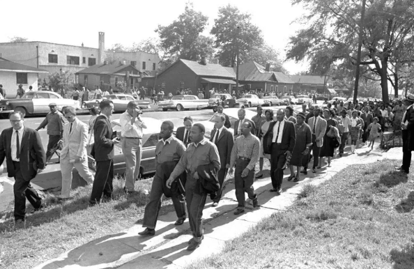 In this file photo taken April 12, 1963 Rev. Ralph Abernathy, left, and Rev. Martin Luther King Jr. lead a column of demonstrators as they attempt to march on Birmingham, Ala., City Hall. Arrested for leading a march against racial segregation in 1963, King Jr. spent days in solitary confinement writing his “Letter From Birmingham Jail,” which was smuggled out and stirred the world by explaining why Black people couldn’t keep waiting for fair treatment. (AP Photo/Horace Cort)