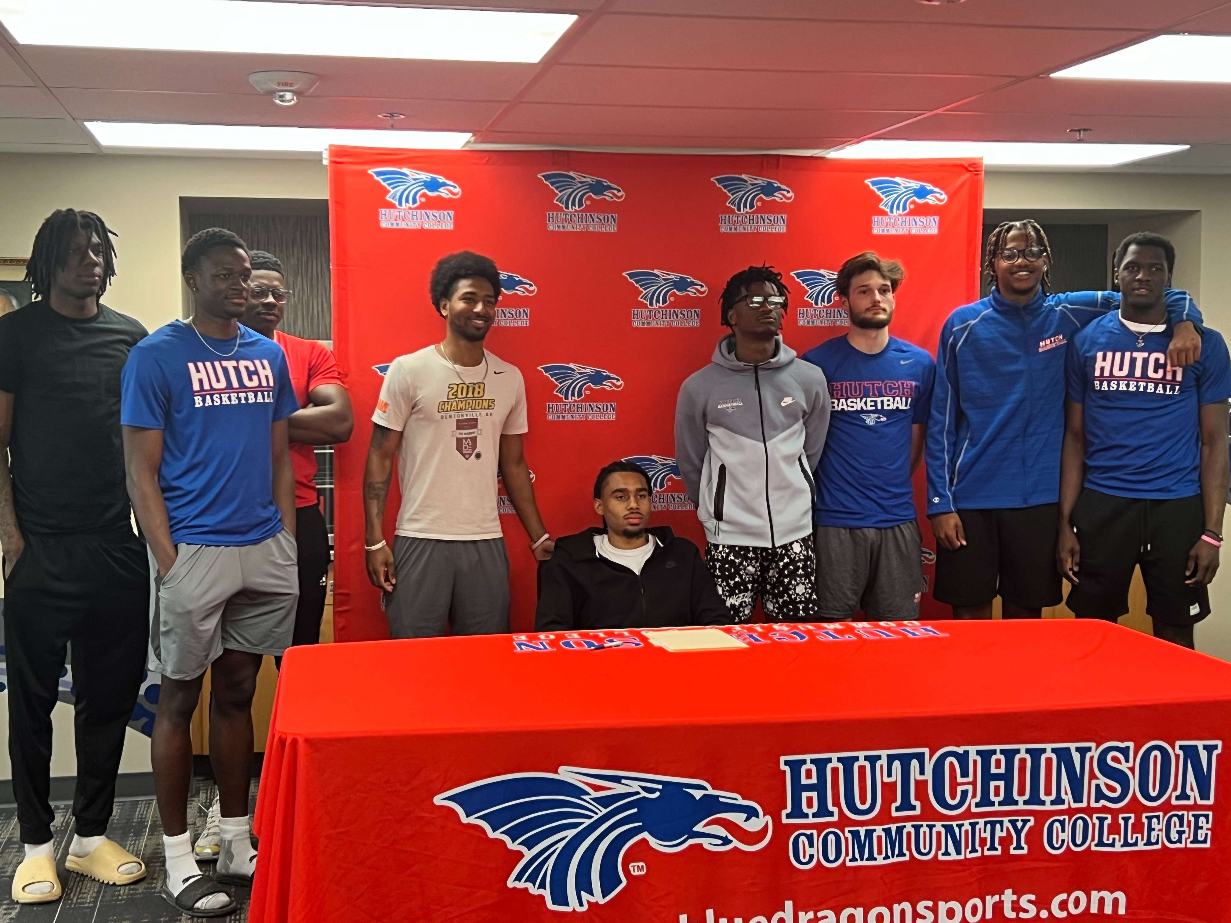 HutchCC sophomore Kamryn Thomas is surrounded by teammates in the Club 1928 Room at the Hutchinson Sports Arena on Wednesday, April 17, 2024. (Hutch Post Photo/Sean Boston)