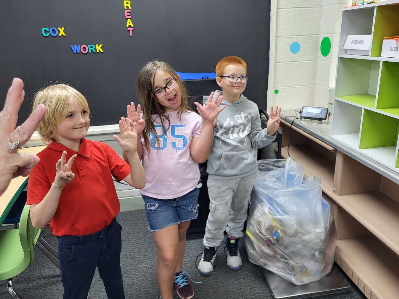 Boys and Girls Club members weigh the trash they were able to pick up around their site.