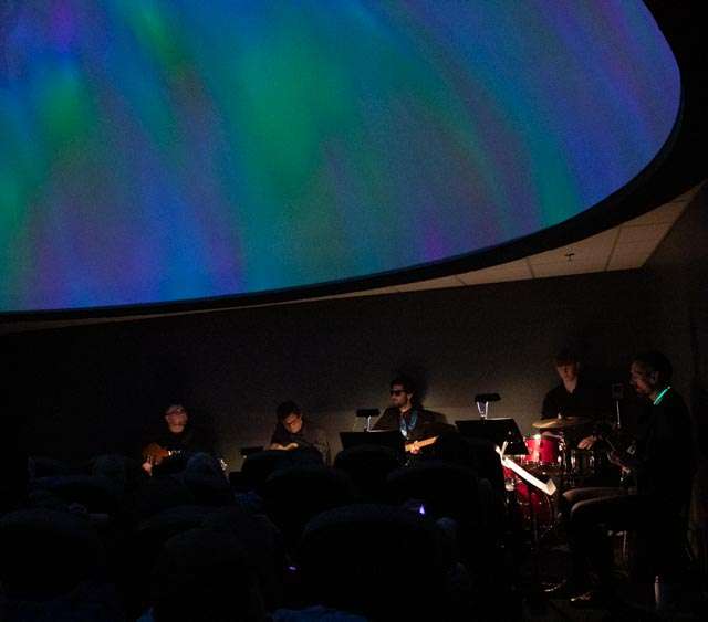 Chadron State College's Guitar Ensemble performs April 28, 2023, in the Veath Planetarium in the Math Science Center of Innovative Learning. (Photo by Tena L. Cook/Chadron State College)