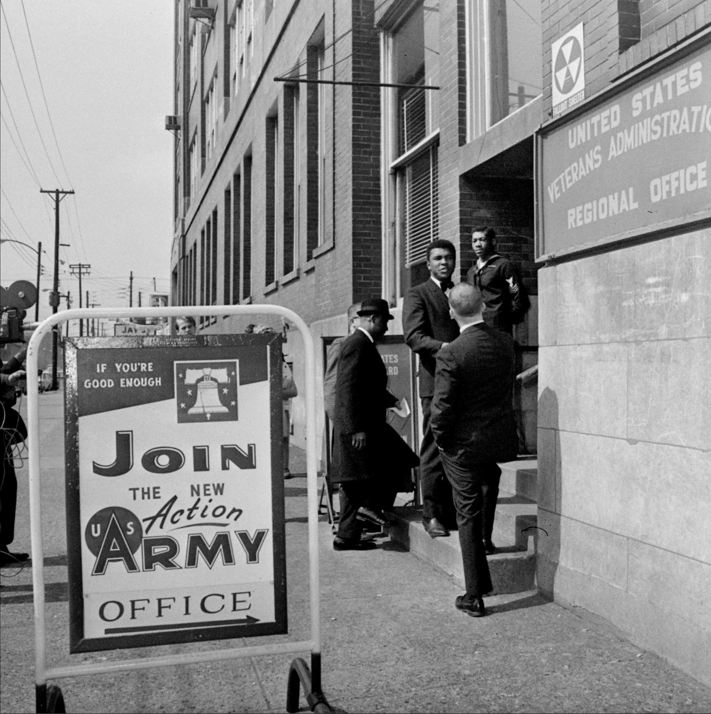 In this March 17, 1966 file photo, heavyweight boxing champ Muhammad Ali greets a friend as he arrives at a veterans administration office in Louisville, Ky., to appeal his 1A draft classification. Citing his religious convictions, Ali refused to be drafted in the U.S. Army. He was stripped of his heavyweight title and didn't box for more than three years. The U.S. Supreme Court overturned his conviction on draft evasion charges. <b>(AP Photo)</b>