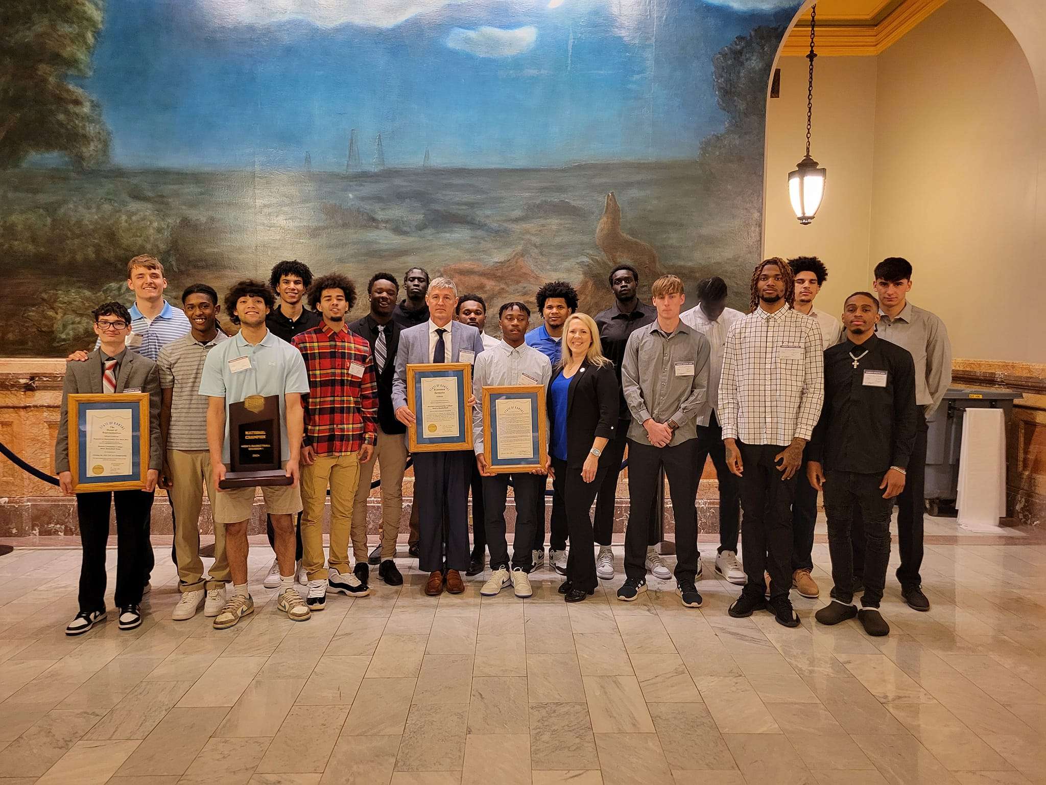 The Barton Community College men's basketball team pictured with Senator Alicia Straub from Ellinwood.