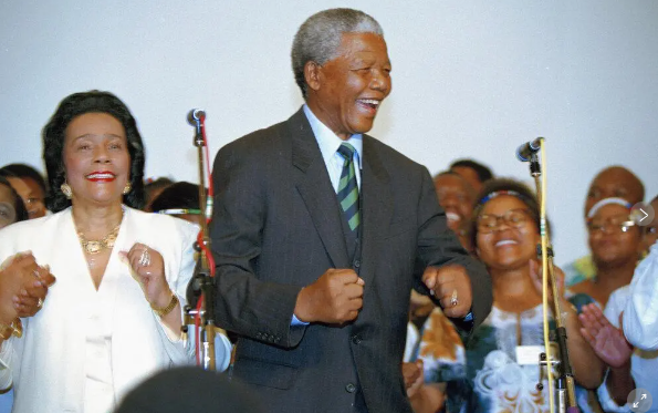 &nbsp; Nelson Mandela, African National Congress leader, and Coretta Scott King, widow of slain civil rights leader Martin Luther King, Jr., sing and dance at a victory celebration for Mandela in Johannesburg, May 2, 1994, after Mandela and the ANC appeared to take the majority of the votes in the country's first integrated elections. (AP
Photo/David Brauchi)&nbsp;&nbsp;
