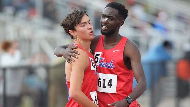 Blue Dragon runners Titus Kiprotich (right) and Farrin Mangelson celebrate after their 2-3 finish in the men's 5,000 meters which secured a third-place Region VI team performance for Hutchinson Saturday in Pratt. (Billy Watson/Blue Dragon Sports Information)