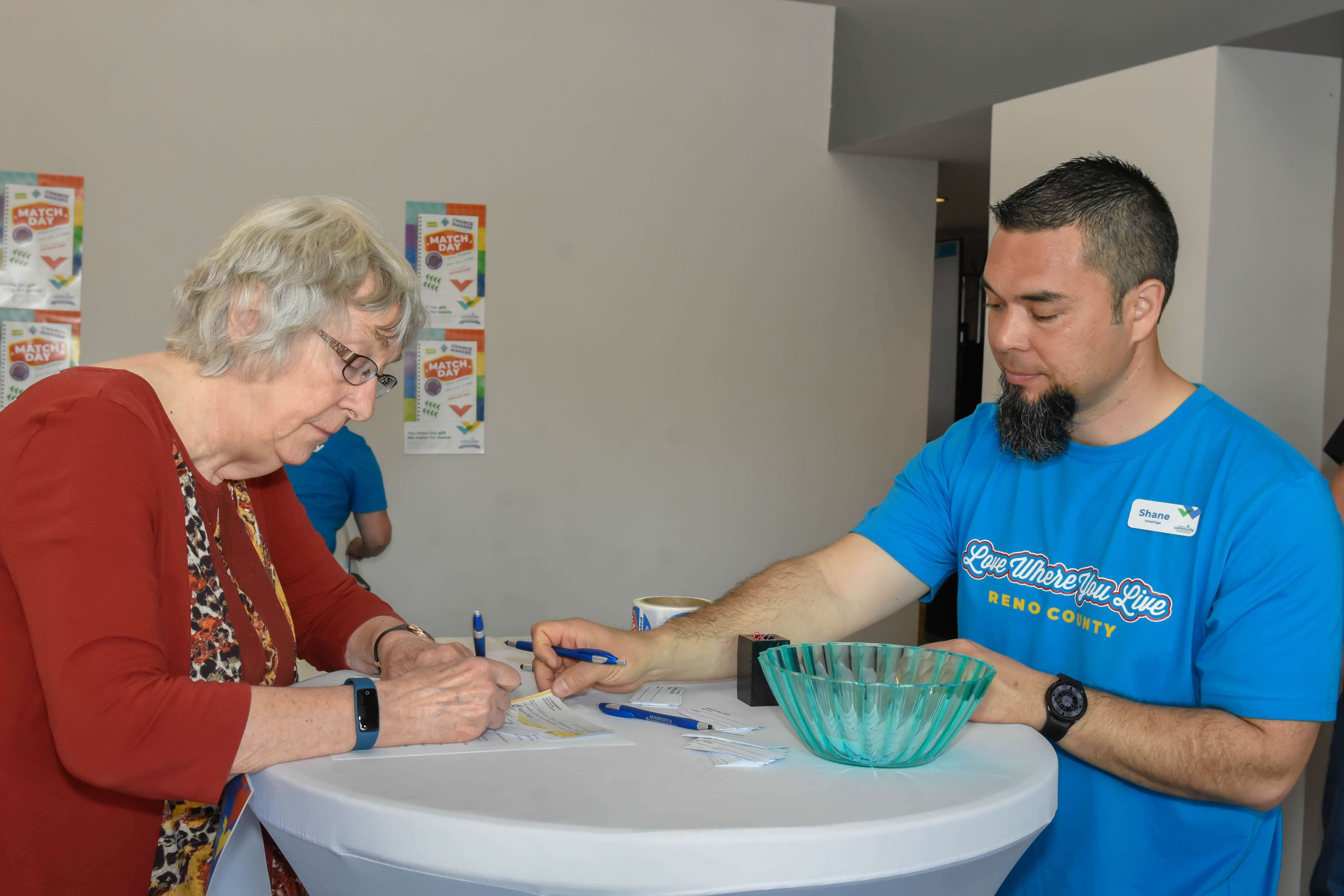 Hutchinson Community Foundation board member Shane Iwashige awaits a donor’s completed Giving Form and donation during Match Day on May 1 at the Wiley Building in downtown Hutchinson. (Credit: Kristen Garlow Piper).