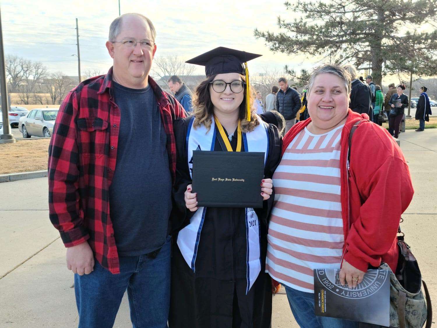 Kaitlin Sill (middle) pictured with her mother and stepfather. Sill, recently hired by Barton Community College, becomes the fourth generation of her family to work at the college.