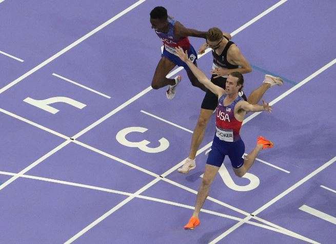Cole Hocker, of the United States, right, celebrates after setting a new Olympic record winning the men's 1,500-meter final at the 2024 Summer Olympics, Tuesday, Aug. 6, 2024, in Saint-Denis, France. (AP Photo/David J. Phillip)