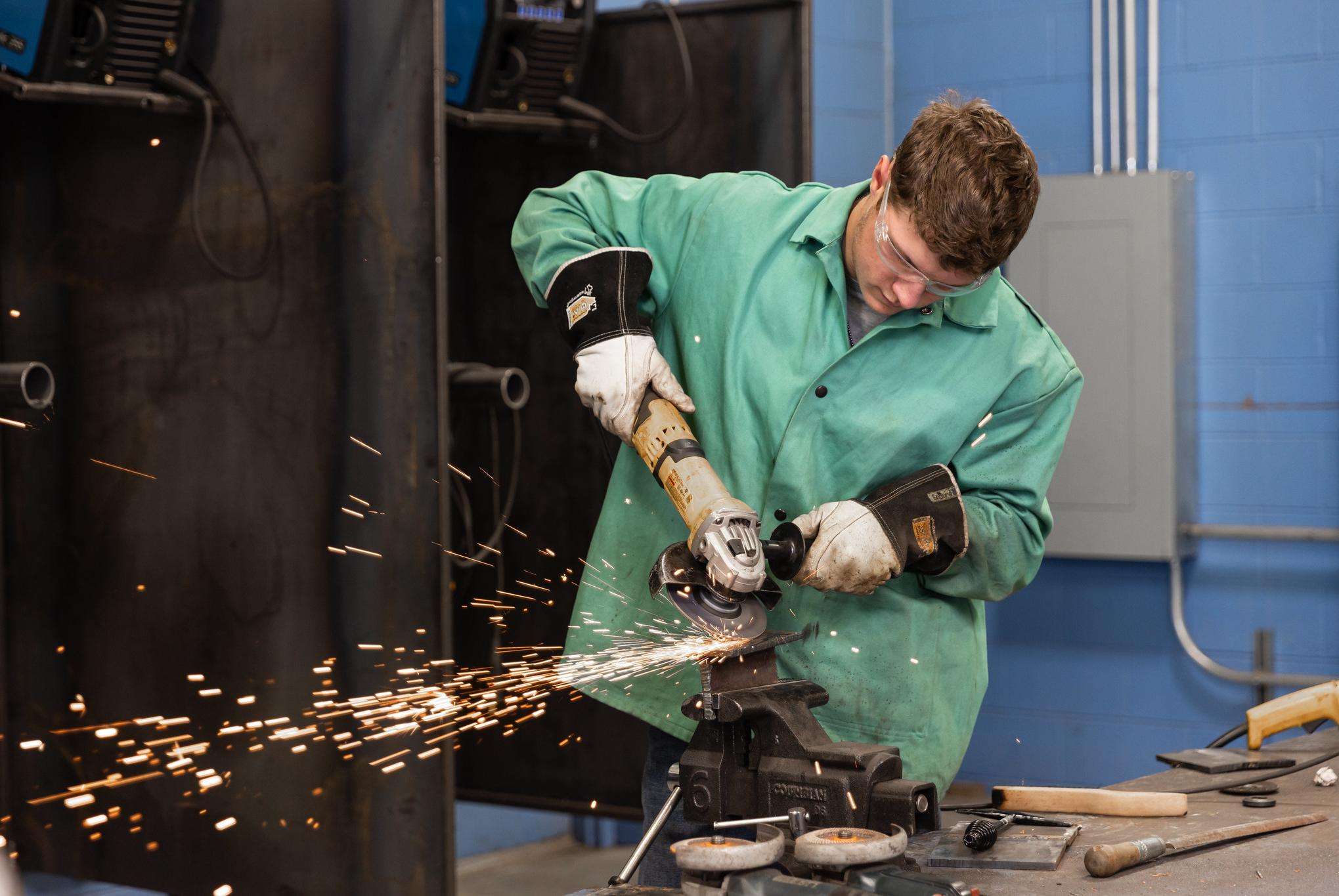 Great Bend High School senior Ethan Hammeke grinds a piece of metal in Barton’s welding lab during the past spring semester.