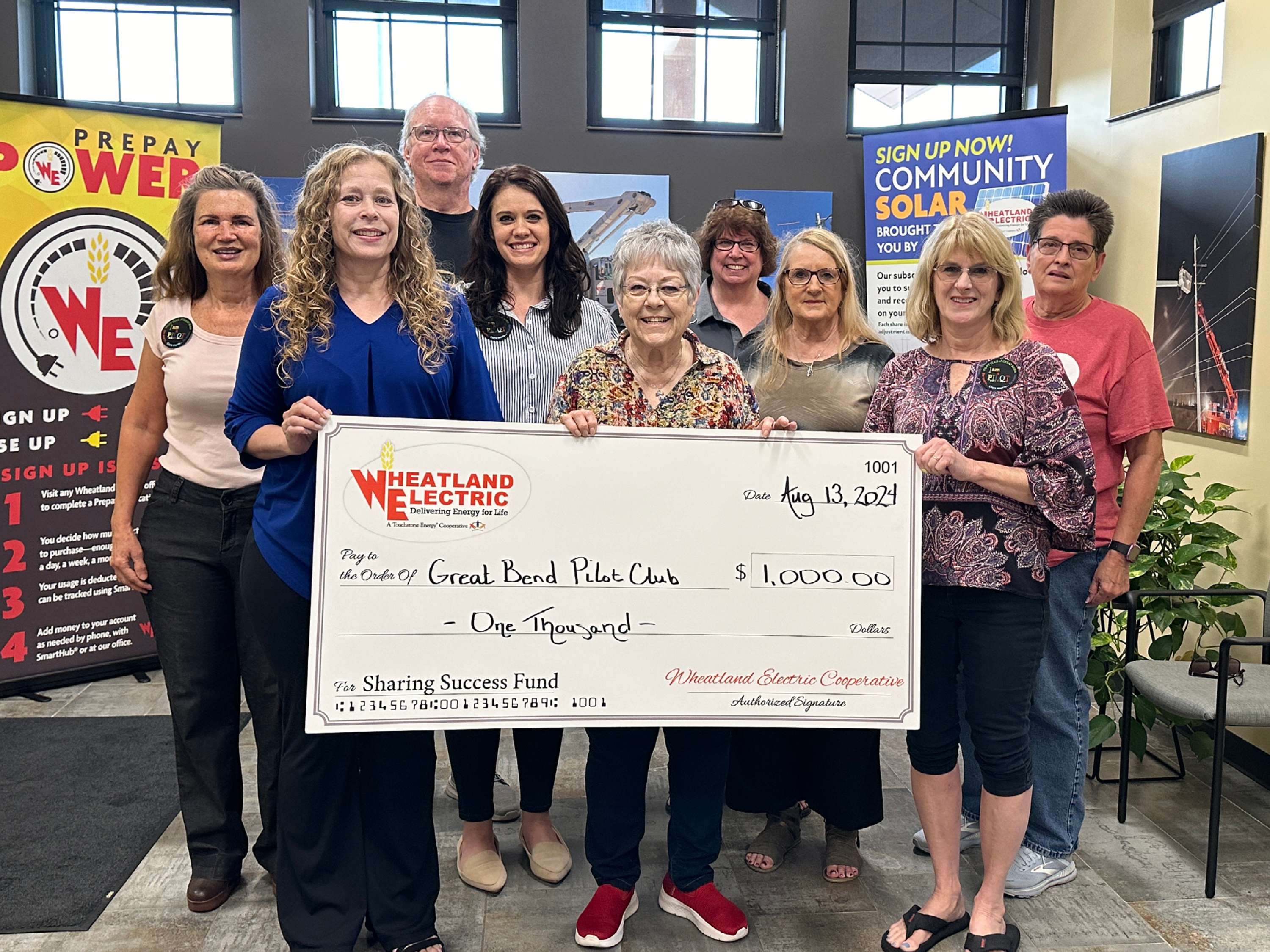 Mary Hoisington, member services and key accounts manager for Wheatland Electric Cooperative, (front left) presents Pilot Club of Great Bend a $1,000 Sharing Success grant to help underwrite an upcoming autism workshop designed to educate teachers and families about available support and services for individuals with autism spectrum disorders (ASD).