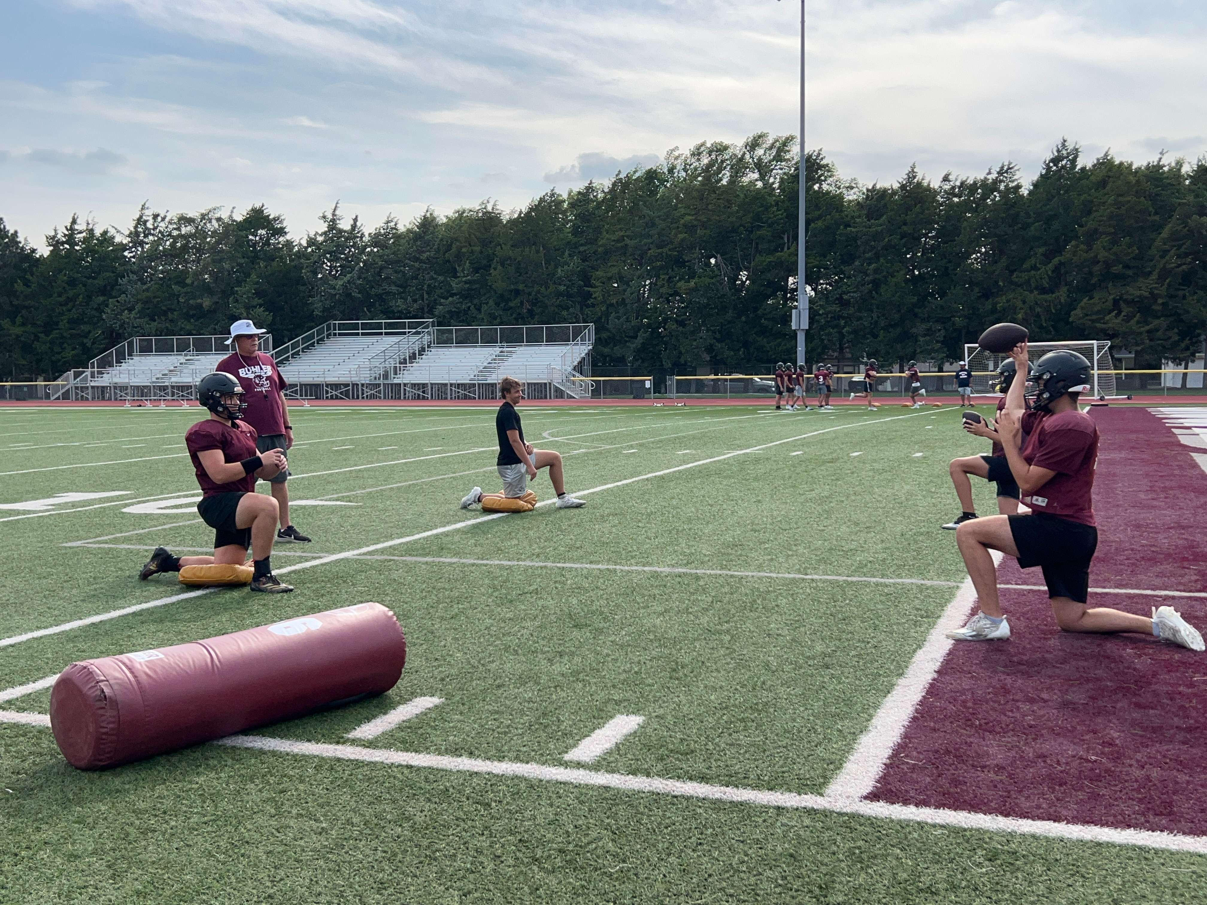 Buhler head football coach Steve Warner looks on as his quarterbacks throw during a practice on Wednesday, Aug. 21, 2024. (Hutch Post Photo/Sean Boston)