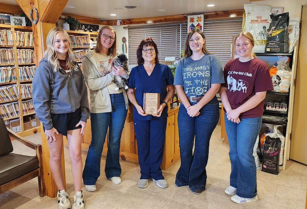 Chadron State College students and members of the Pre-Veterinary Club pose with recipient of the Title IX Trailblazer Award, Dr. Regina Rankin, center, in her Crawford Clinic on Sept. 17, 2024. From left, Kiauna Hargens, Natalie Hamaker holding Maddie, Dr. Regina Rankin, Autumn Skow, and Ashlyn Tapio. (Courtesy photo, used with permission)