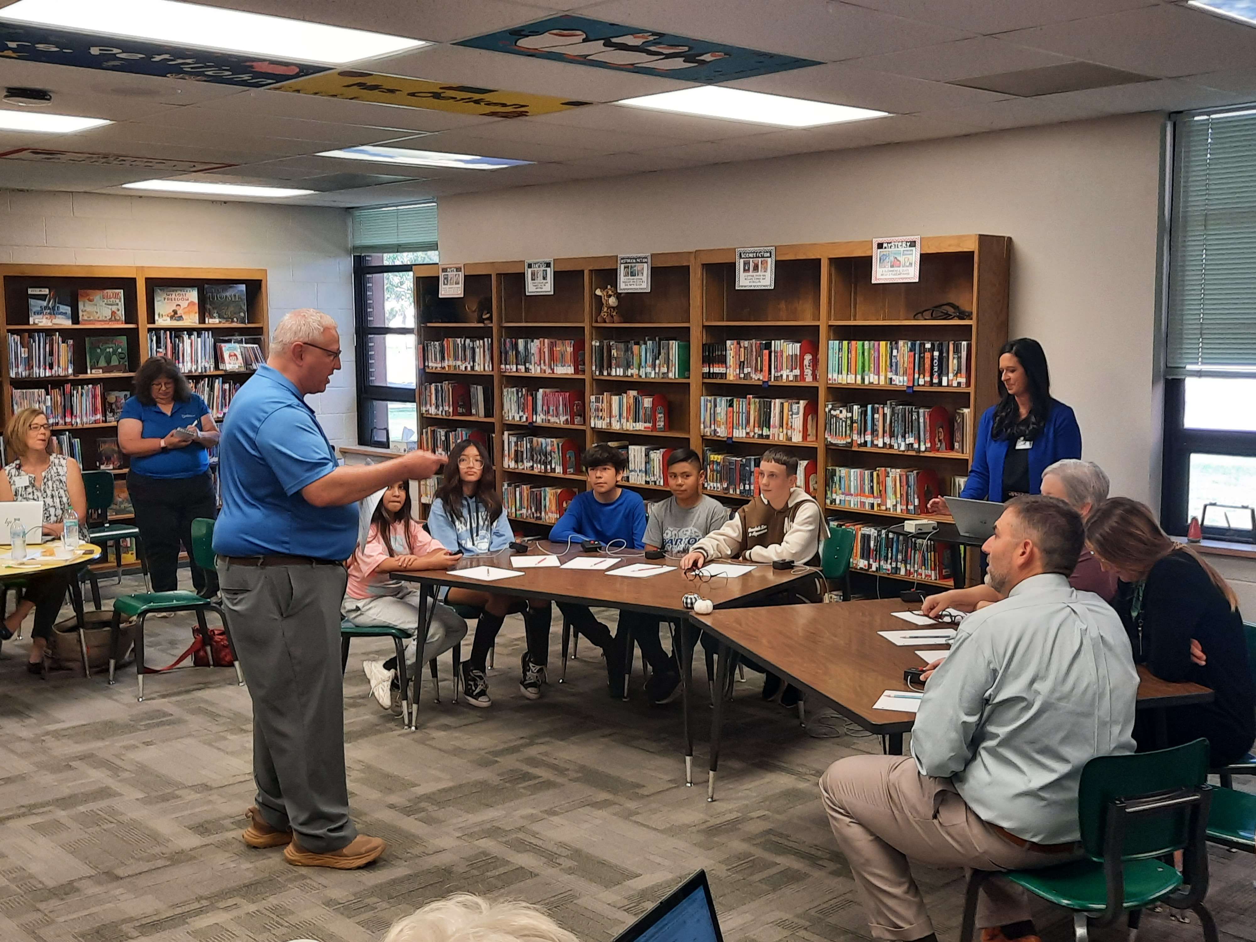 Eric Dowson, sixth-grade teacher and Scholar Bowl sponsor at Park Elementary School, reads quiz questions to Scholar Bowl members and educators during Wednesday's BOE luncheon at the school. 